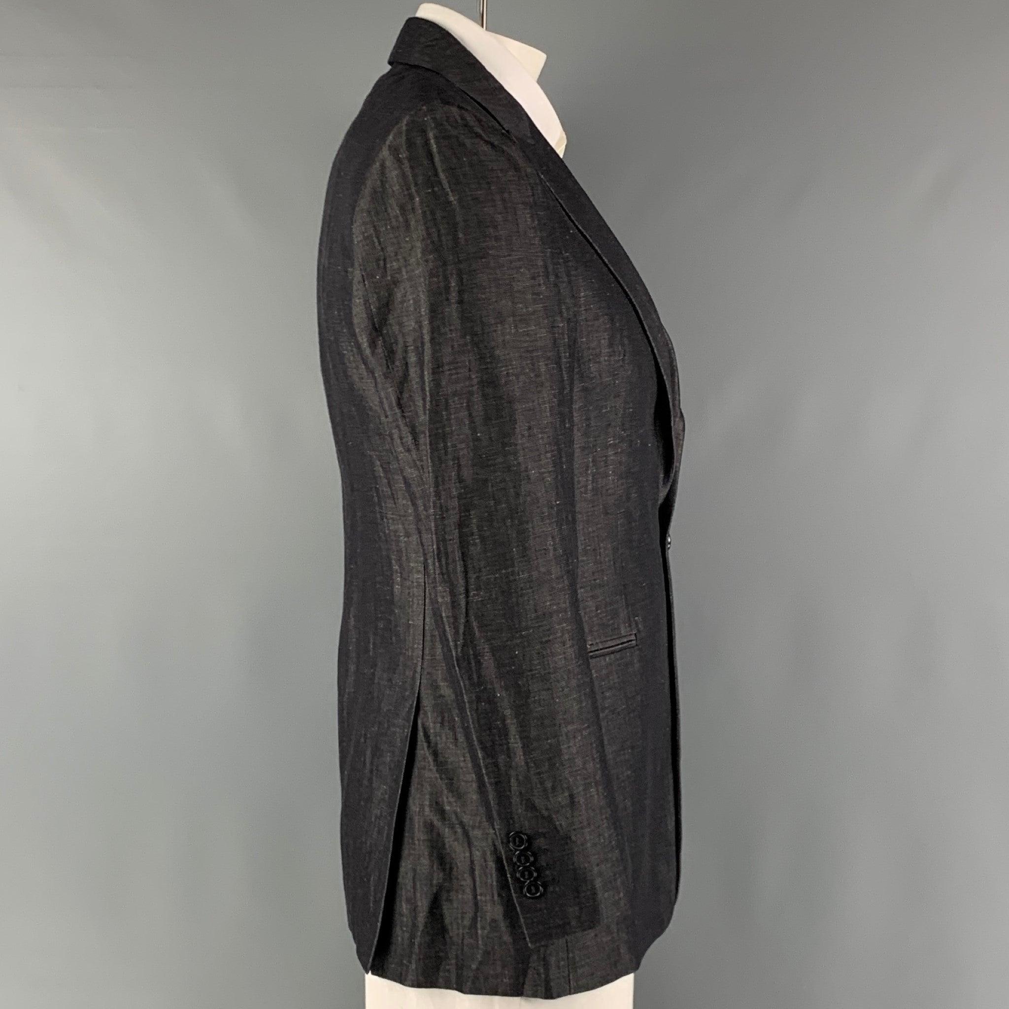 EMPORIO ARMANI sport coat comes in a charcoal twill woven material with a full liner featuring a single breasted, single button closure, welt pockets, peak lapel and double back vent. Made In Italy.Very Good Pre-Owned Condition.
Fabric Tag Removed.