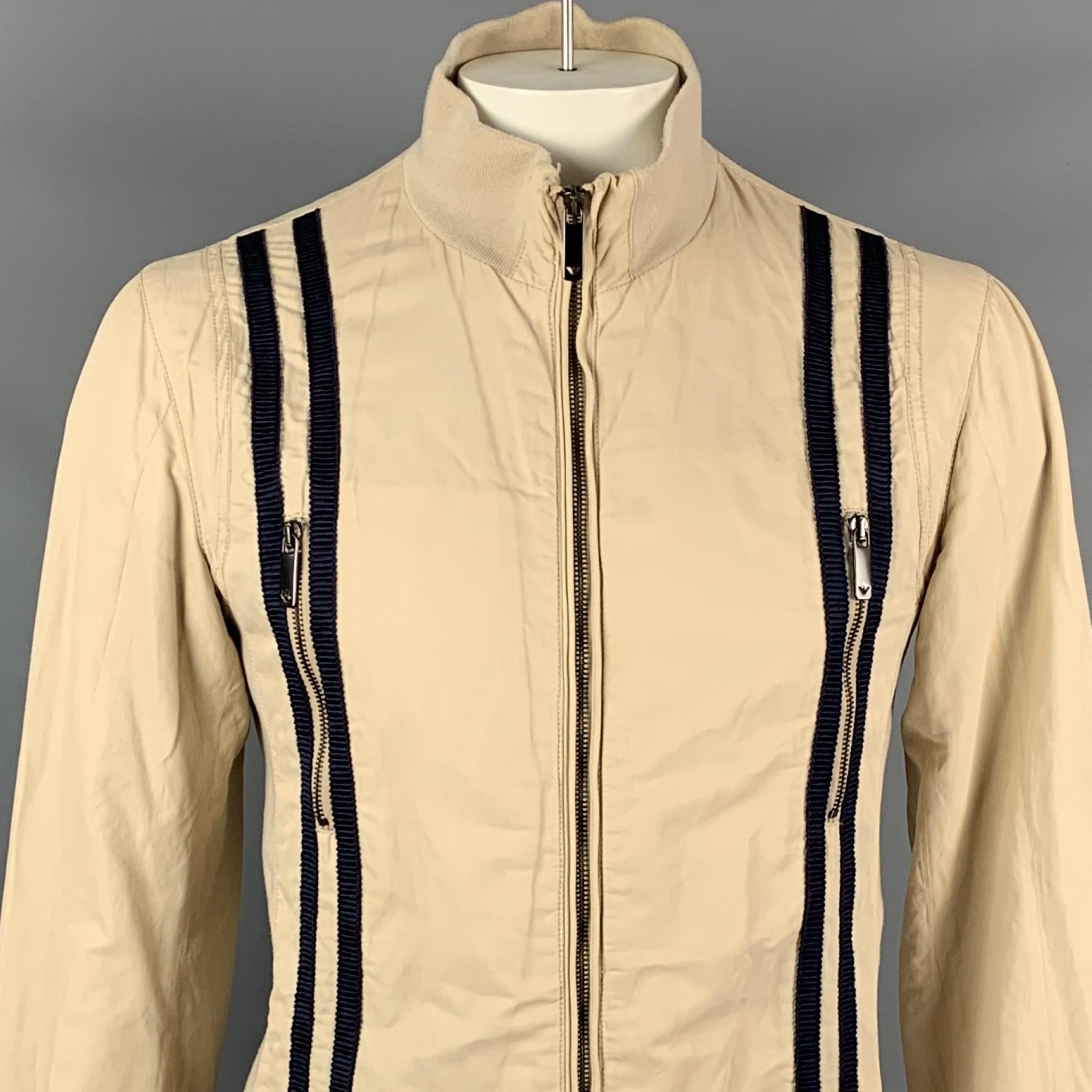 EMPORIO ARMANI jacket comes in a khaki cotton with a full liner featuring a navy trim, zipper details, high collar, front pockets, and a full zip up closure. 

Good Pre-Owned Condition. Light mark a front.
Marked: 52

Measurements:

Shoulder: 18