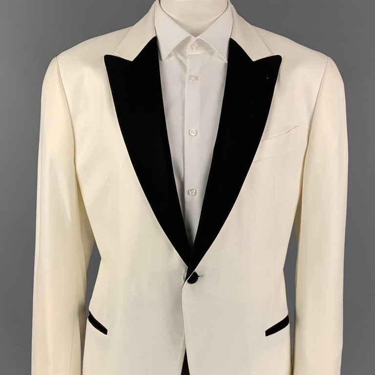 EMPORIO ARMANI sport coat comes in a white viscose with a full liner featuring a black peak lapel, slit pockets, double back vent, and a single button closure. Made in Bulgaria. 

Very Good Pre-Owned Condition.
Marked: 58

Measurements:

Shoulder: