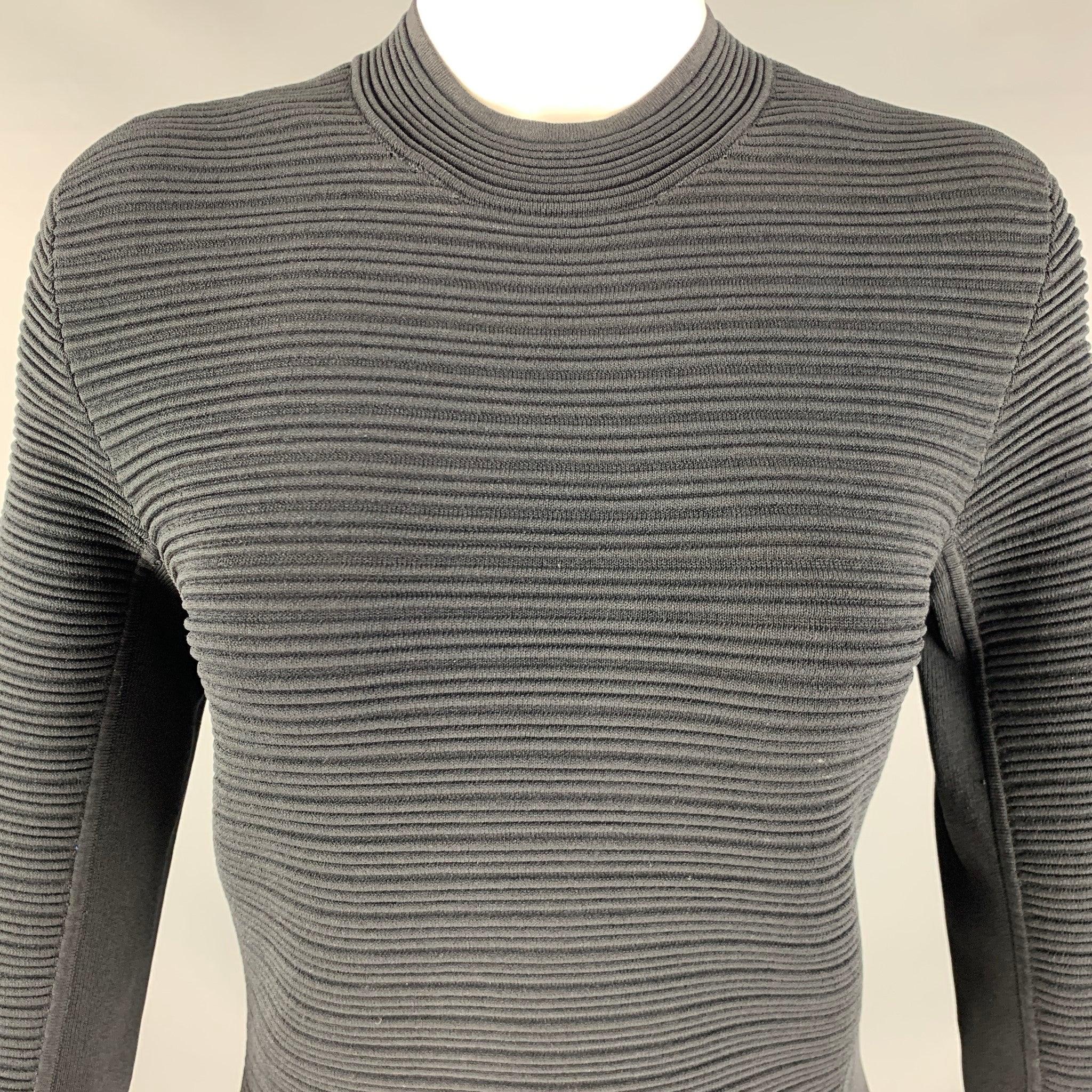 EMPORIO ARMANI
dress in a black fabric featuring a stretchy form-fitting look, ribbed texture, and mid-calf length.Excellent Pre-Owned Condition. Fabric tags removed. 

Marked:  Size not marked. 

Measurements: 
 
Shoulder: 16 inches Sleeve: 15