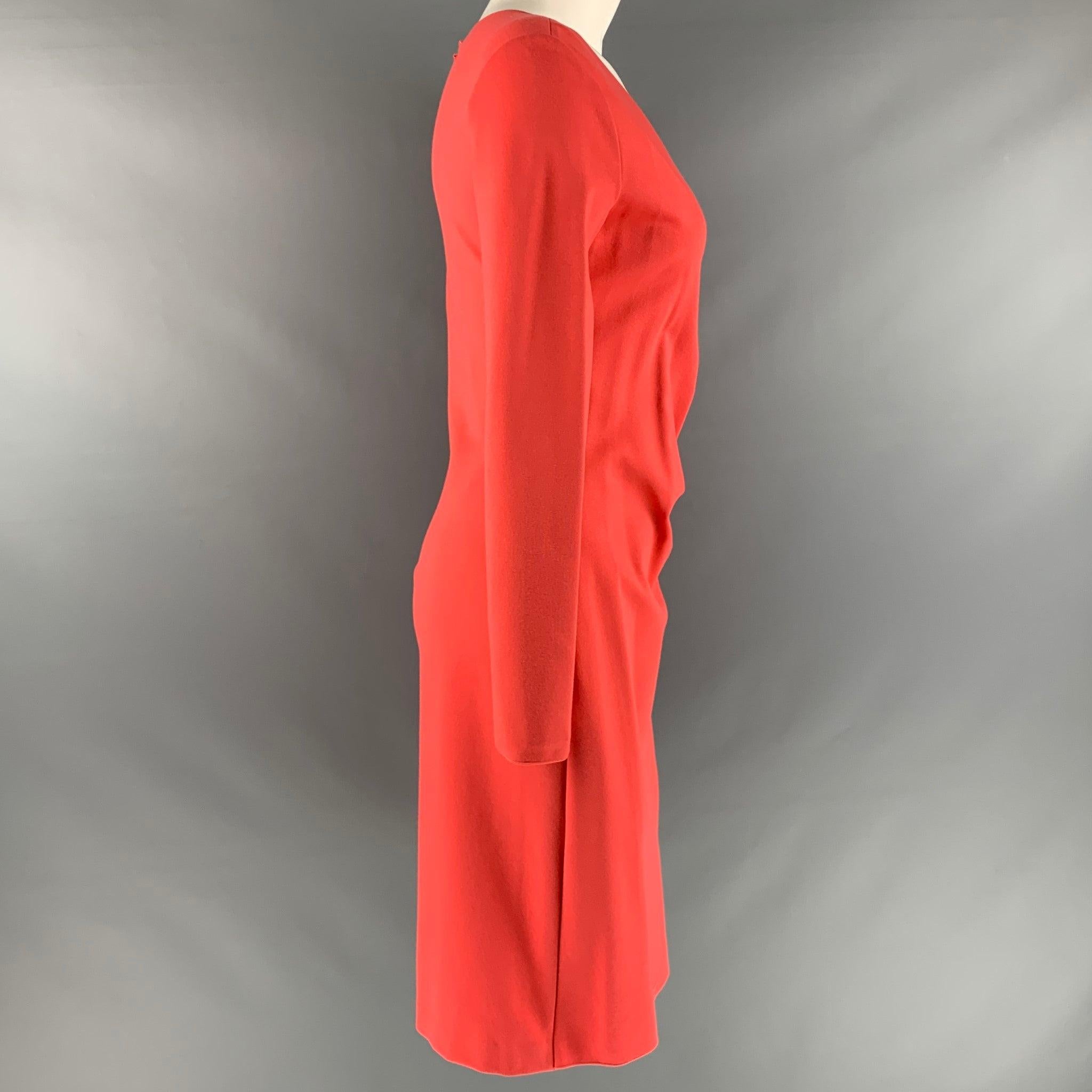 EMPORIO ARMANI
dress in an orange viscose blend fabric featuring a faux wrap style, V-neck, long sleeves, and below knee length.Very Good Pre-Owned Condition. Minor signs of wear. 

Marked:  42 

Measurements: 
 
Shoulder: 16.5 inches Sleeve: 23