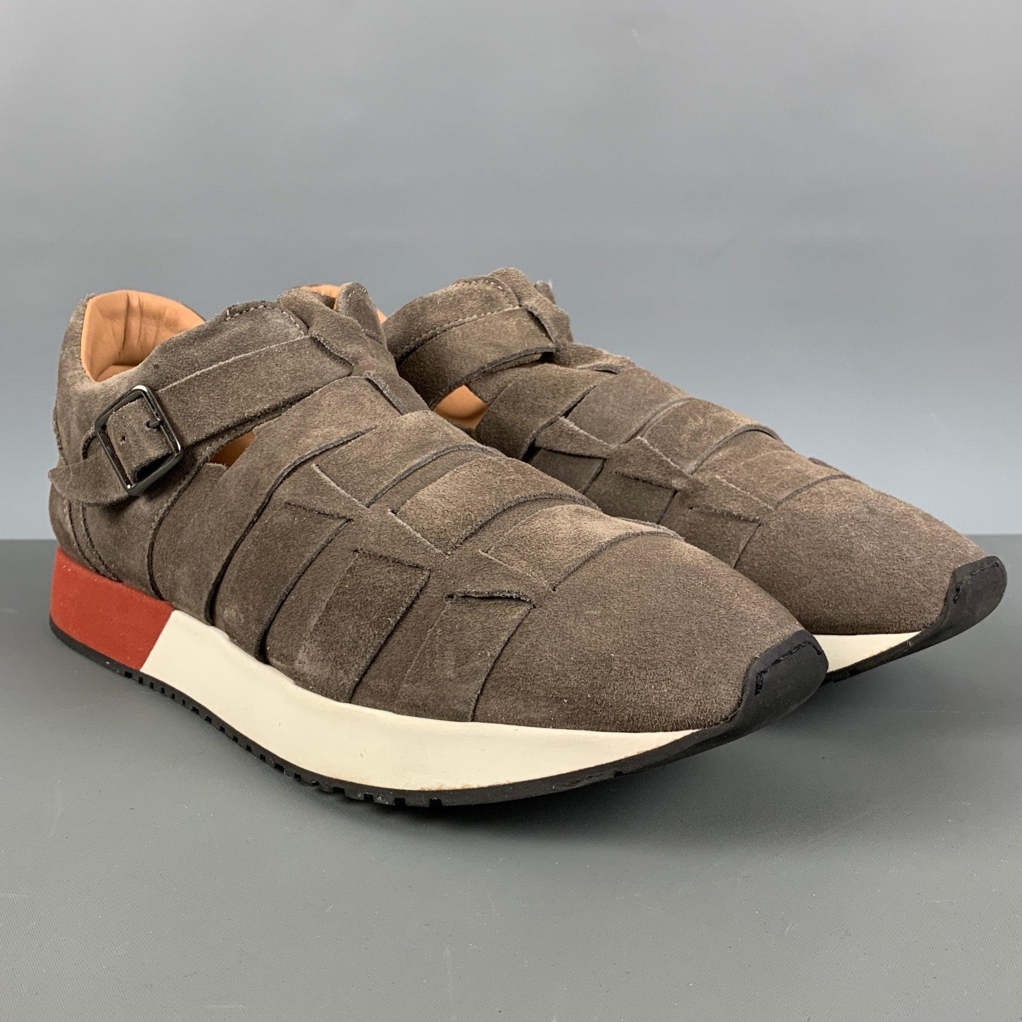 EMPORIO ARMANI sneakers comes in a grey taupe suede leather featuring a low style, rubber sole, and a single buckle closure. Made in Spainches Very Good Pre- Owned Conditions. 

Marked:   X4L039 91/2Outsole: 12.25 inches  x 4.5 inches 
  
  
