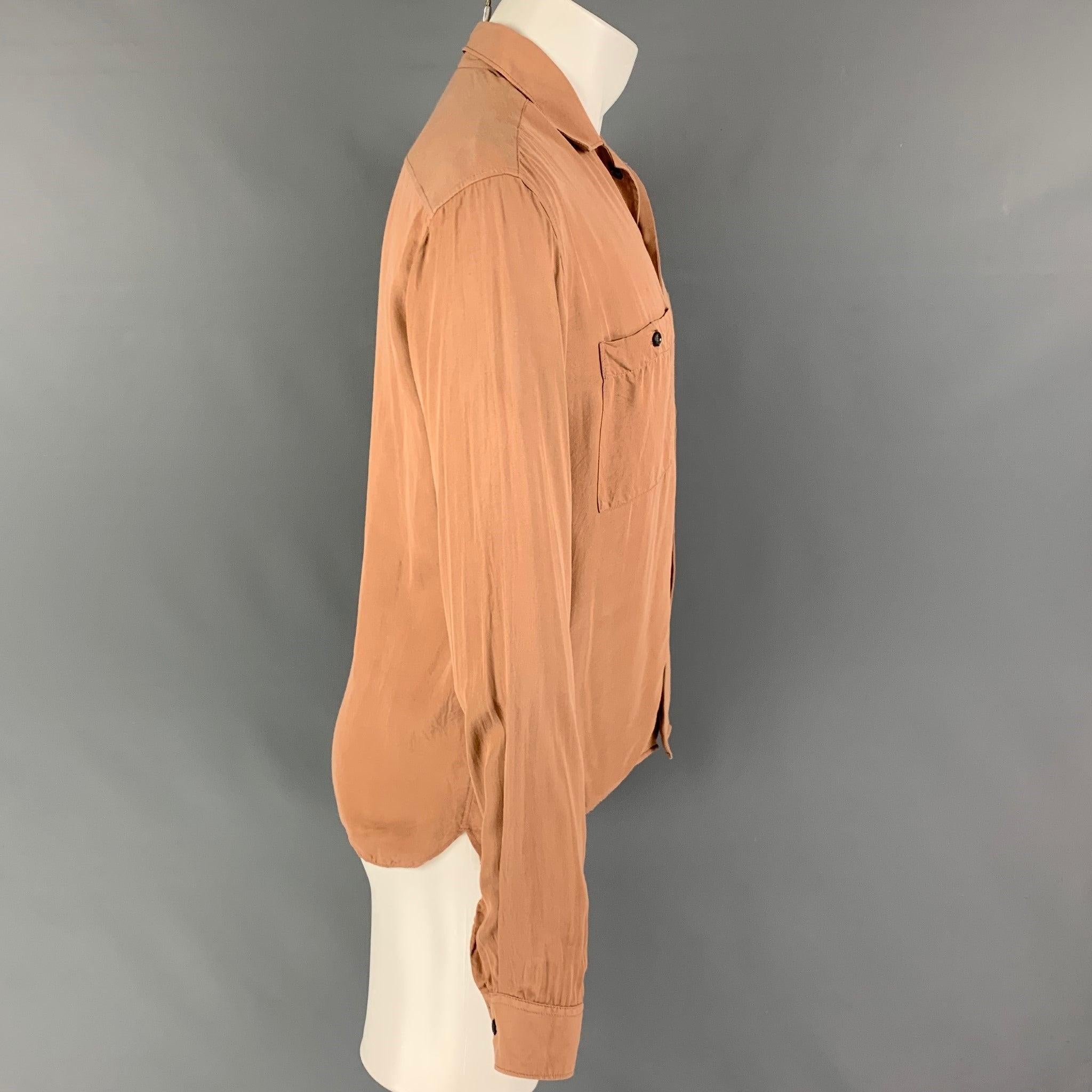 ARMANI long sleeve shirt comes in a mauve material featuring a spread collar, patch pockets, and a button up closure.Very Good
Pre-Owned Condition. 

Marked:   40 - 15 3/4 

Measurements: 
 
Shoulder: 18.5 inches  Chest: 40 inches  Sleeve: 26 inches