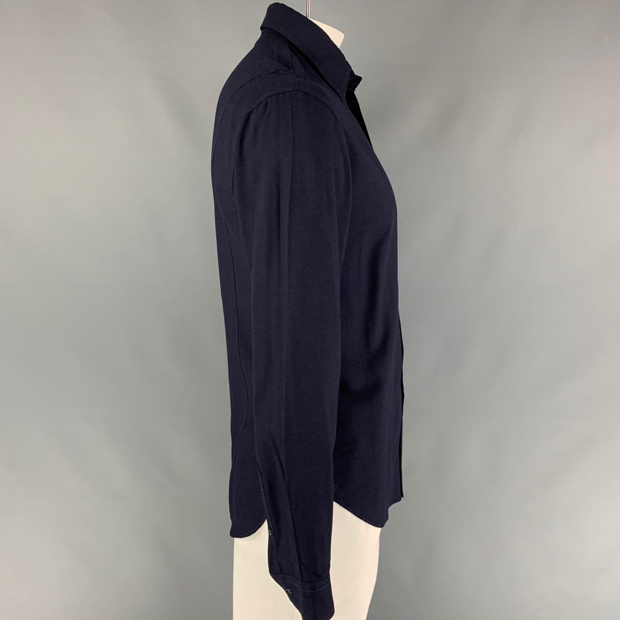 EMPORIO ARMANI long sleeve shirt comes in a navy viscose featuring a classic style, spread collar, and a buttoned closure.
Very Good
Pre-Owned Condition. 

Marked:   M  

Measurements: 
 
Shoulder: 20 inches  Chest: 40 inches  Sleeve: 26.5 inches 