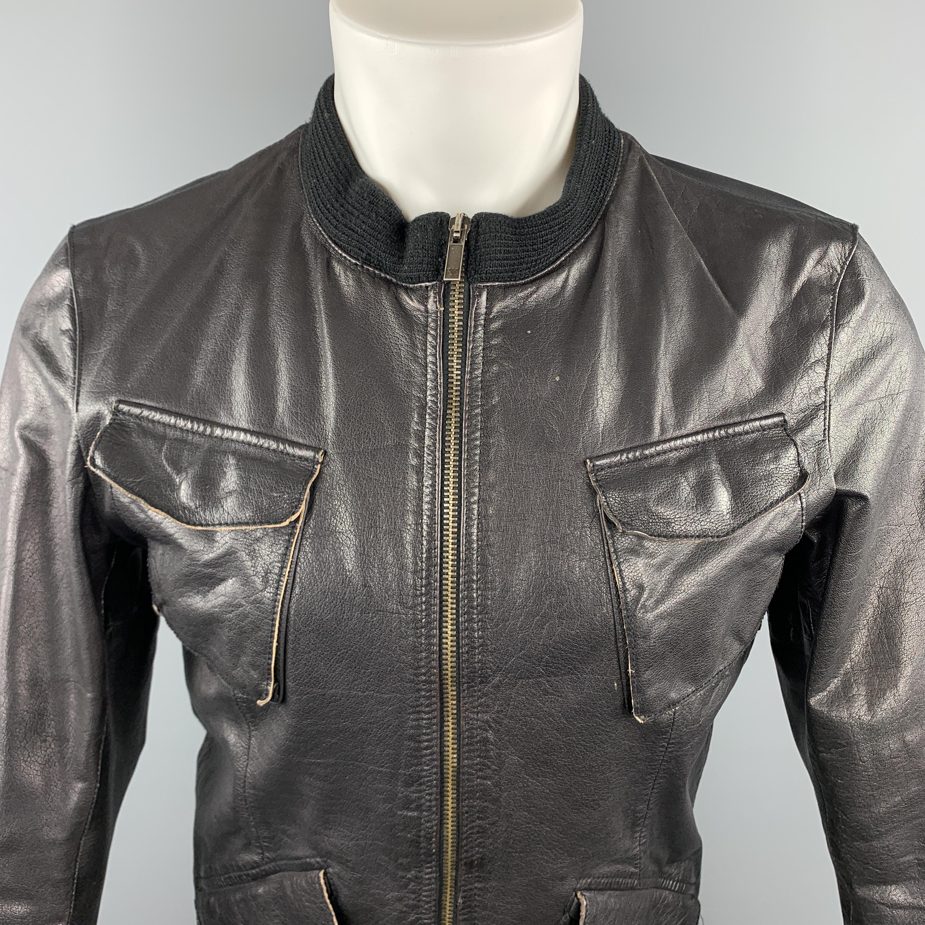 EMPORIO ARMANI jacket comes in a black leather material, with a ribbed collar, zip at closure, patch and flap pockets, snaps at cuffs, featuring a distressed effect. 

Excellent Pre-Owned Condition.
Marked: US 38

Measurements:

Shoulder: 17