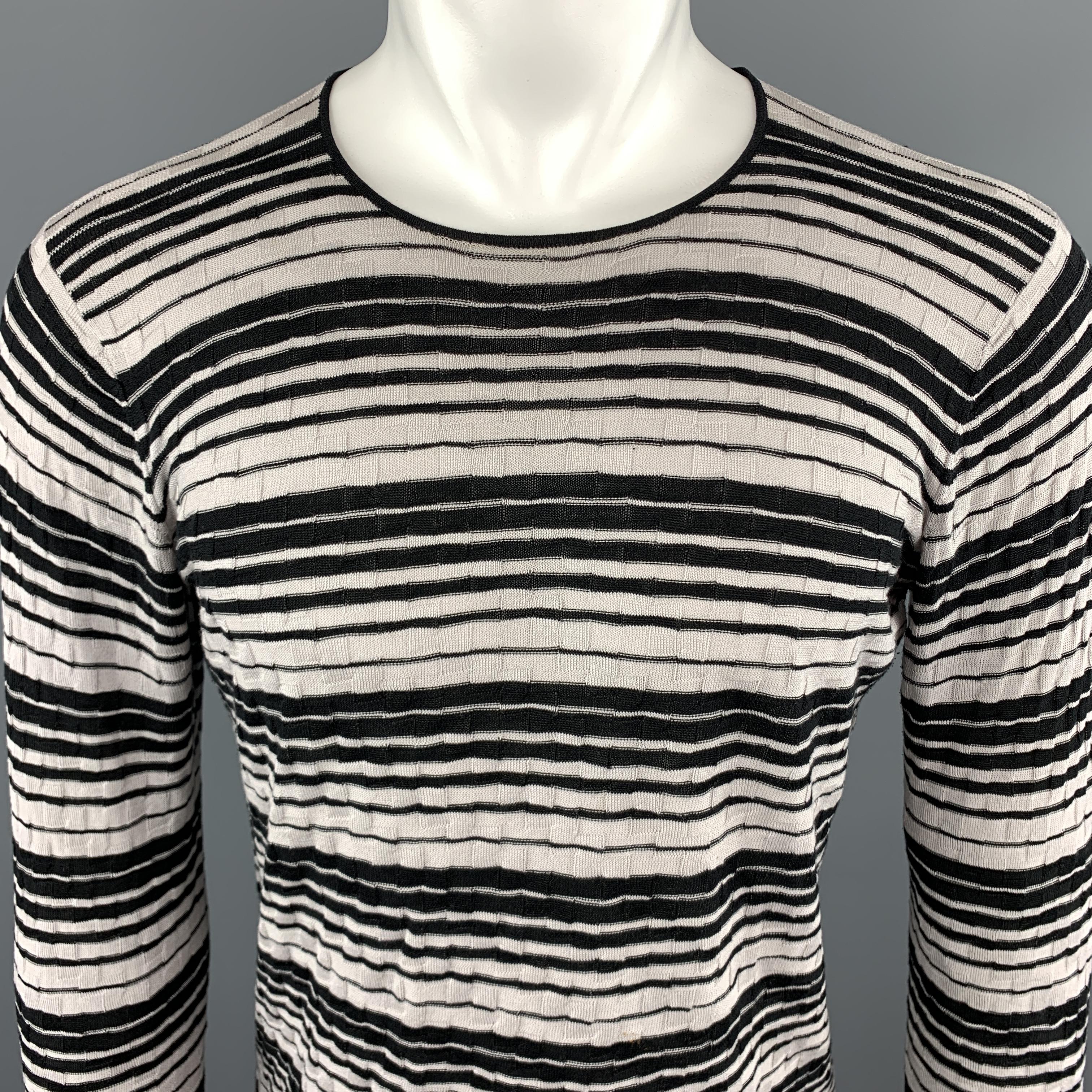 EMPORIO ARMANI Pullover Sweater comes in gray and black tones in a textured material, with a crewneck and a logo embroidered at front. Minor wear at sleeve. 

Very Good Pre-Owned Condition.
Marked: No size

Measurements:

Shoulder: 15 in. 
Chest: 39