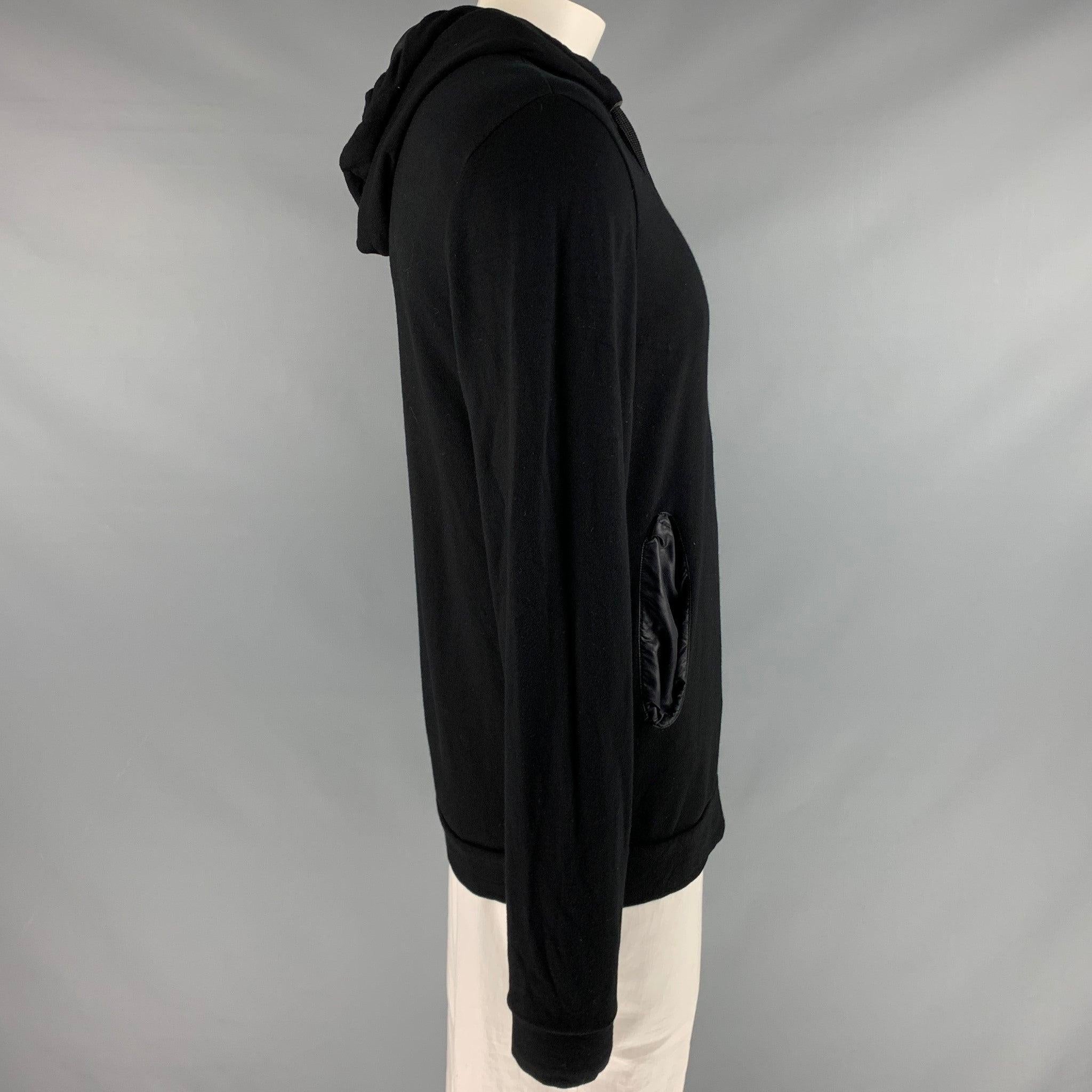 EMPORIO ARMANI sweatshirt
in a stretchy black viscose blend fabric featuring a hooded style, and satin-lined pockets.Very Good Pre-Owned Condition. Minor signs of wear. 

Marked:   XL 

Measurements: 
 
Shoulder: 18 inches Chest: 42 inches Sleeve: