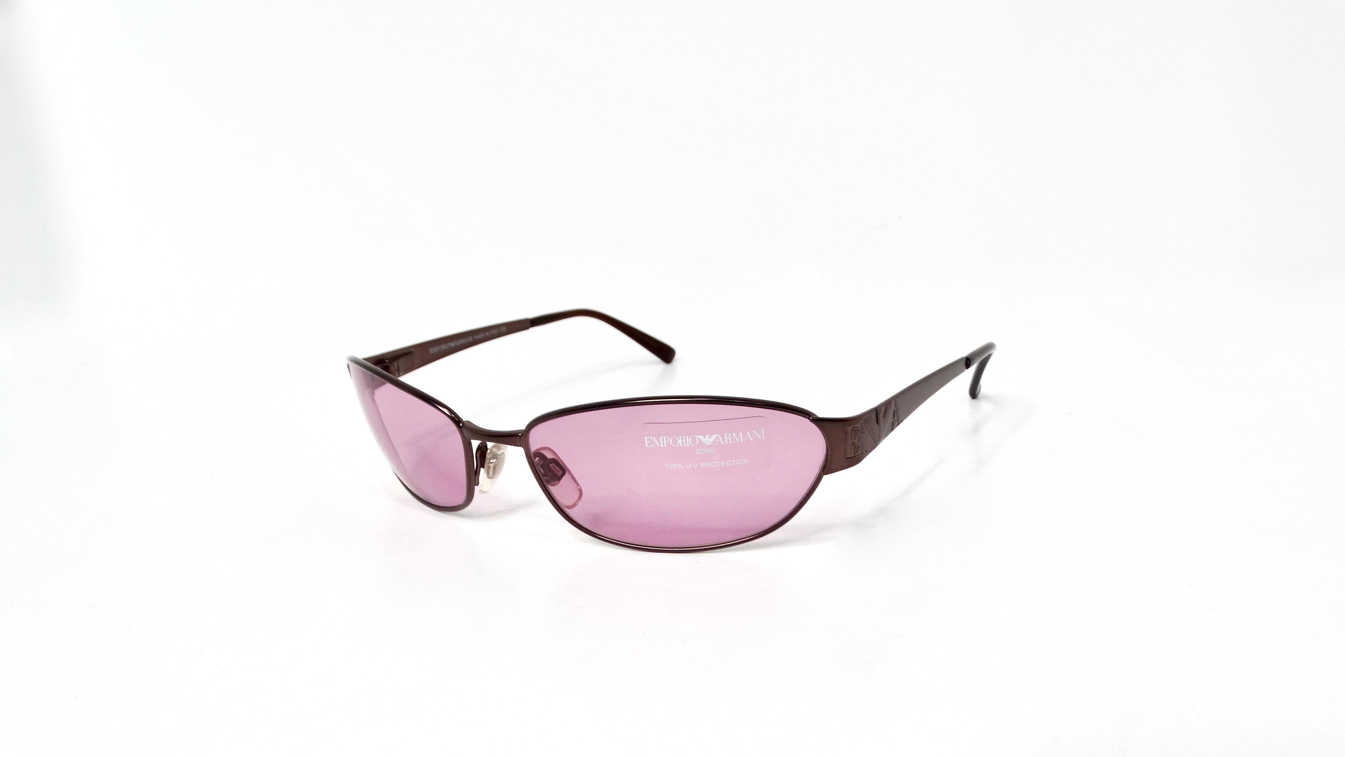 Embrace the nostalgic charm of the early 2000s with the Emporio Armani Y2K Purple Tinted Lens Sunglasses, a must-have accessory for those who appreciate retro-inspired fashion. These striking sunglasses feature a unique purple tint that not only