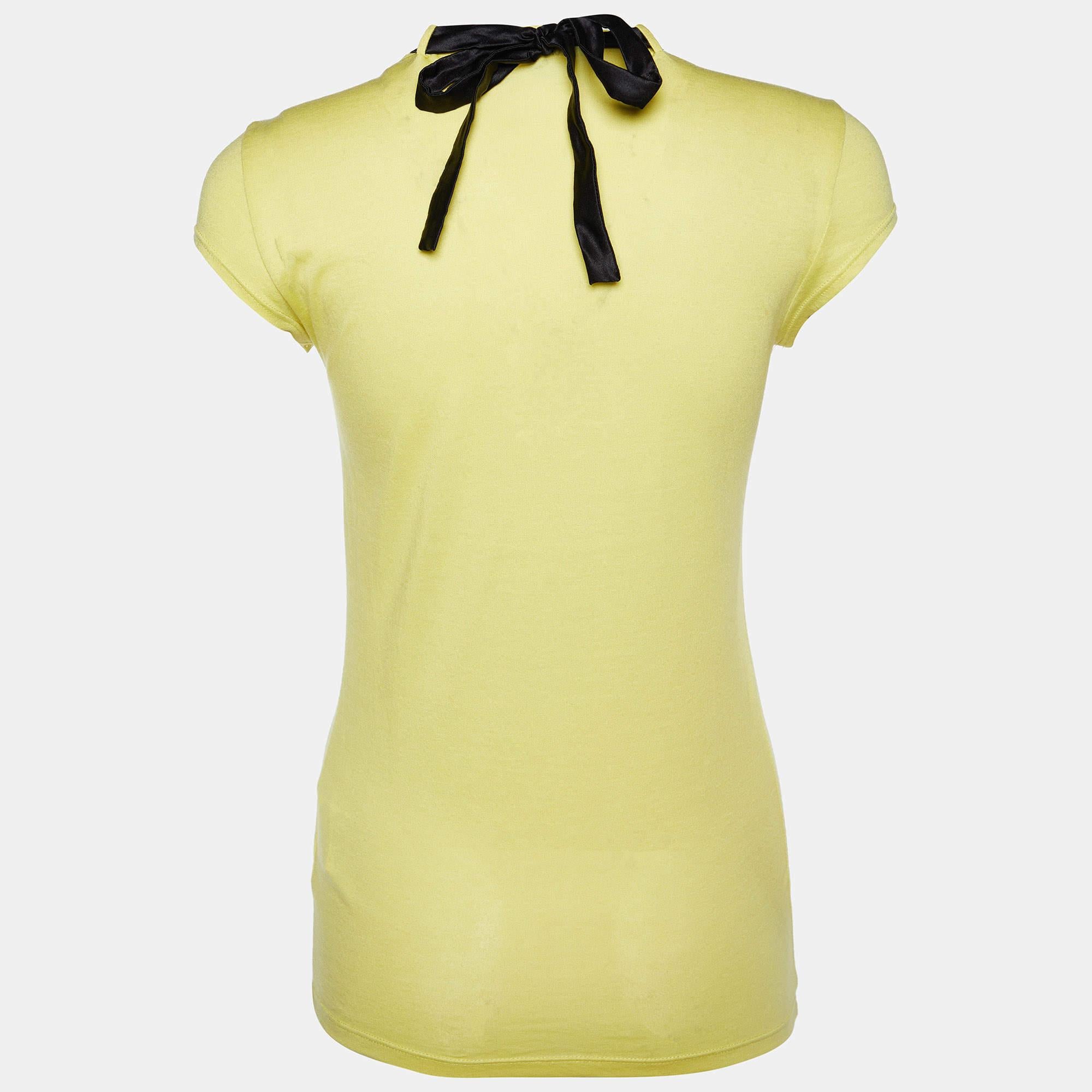 The Emporio Armani t-shirt is a vibrant, high-quality piece of clothing. Made from a blend of soft cotton and modal, it offers luxurious comfort. The standout feature is its intricately embellished neckline, adding a touch of elegance to a casual