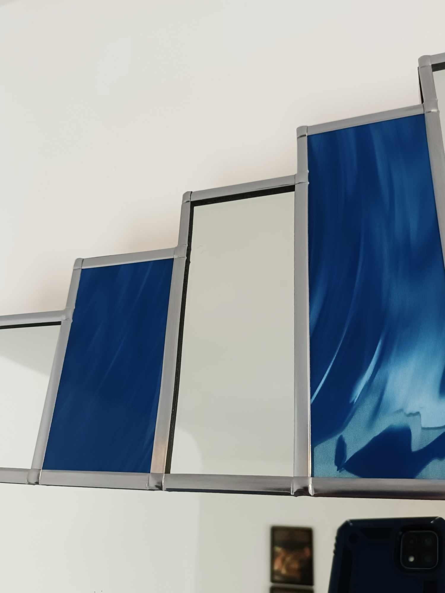 Introducing The Empress, an Art Deco style mirror evoking the glamour of the 1930s! Featuring blue sections in the crown top and classic styling, this statement piece will add an air of elegance to any room. Bring luxury into your home with The