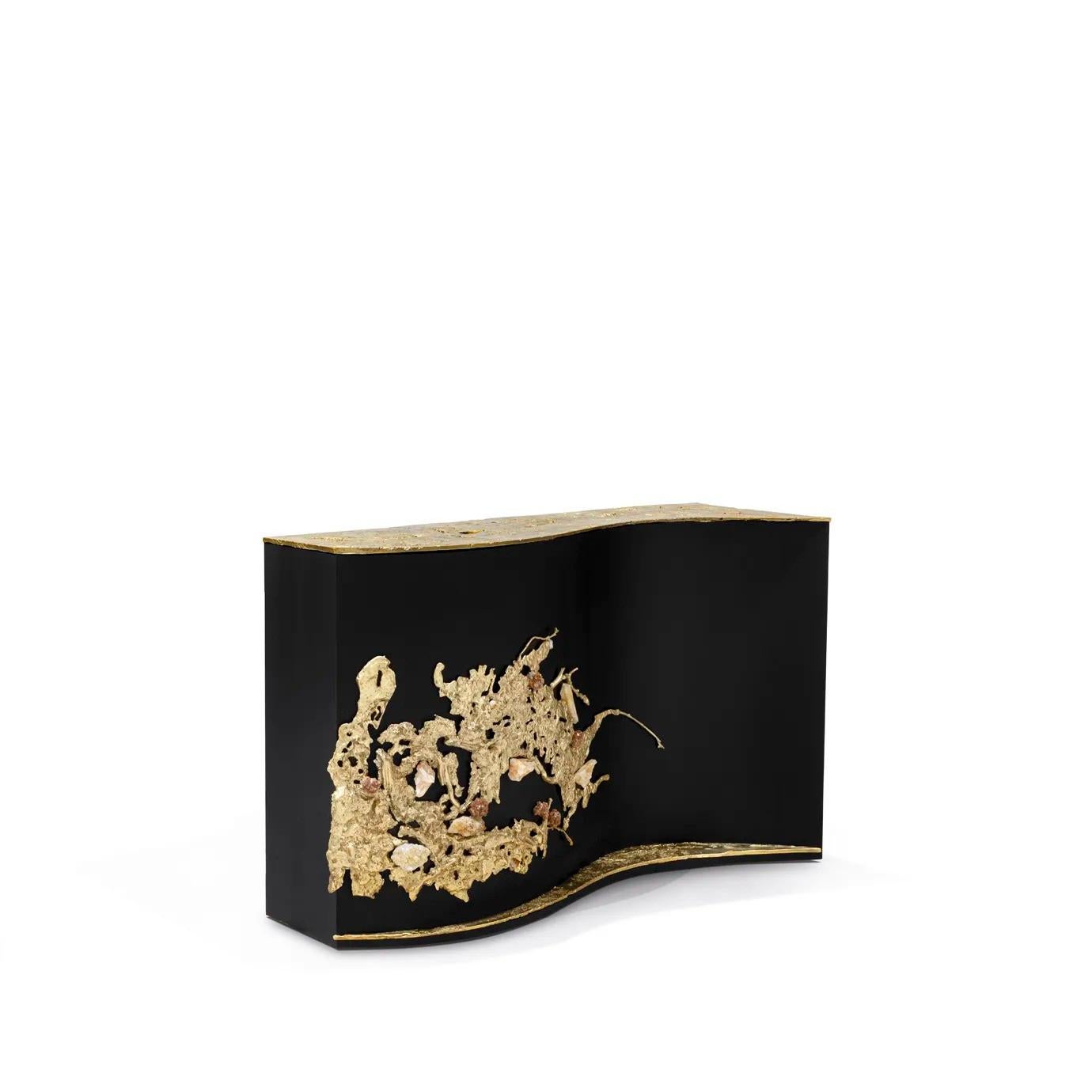 The Empress Console is fully aware of her powers, embraced in her untamed magnetic beauty. Exquisite sand-cast brass entangled with amber rock crystals wildly grows across her sleek, curved, ash-black wood veneer. This statement console, available