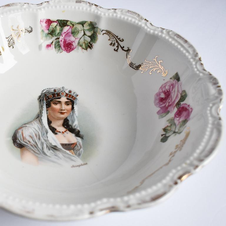 Beautiful round figural and floral motif serving dish of Joséphine Bonaparte by famed porcelain maker PM & M Bavaria, Germany. Round in form, the dish features scalloped edges, with raised dot details and raised whimsical patterns surrounding the