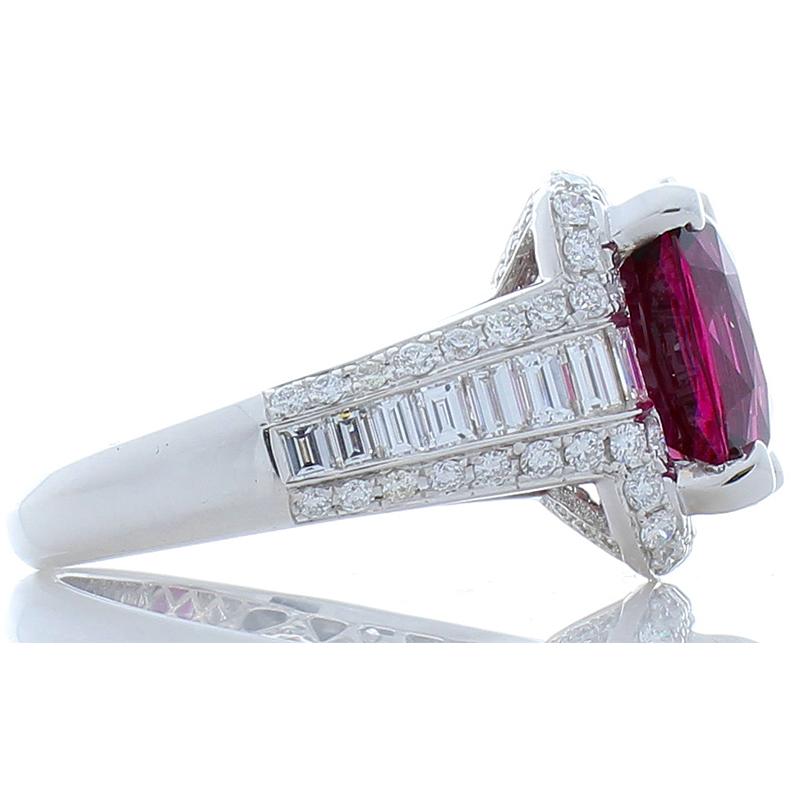 This is a natural vivid purple rhodolite garnet weighing 6.47 carats and measures 12.11x9.84mm skillfully in a prong setting. The gem source is Sri Lanka; its transparency and luster are superb. The luxe raspberry color of this garnet is accentuated