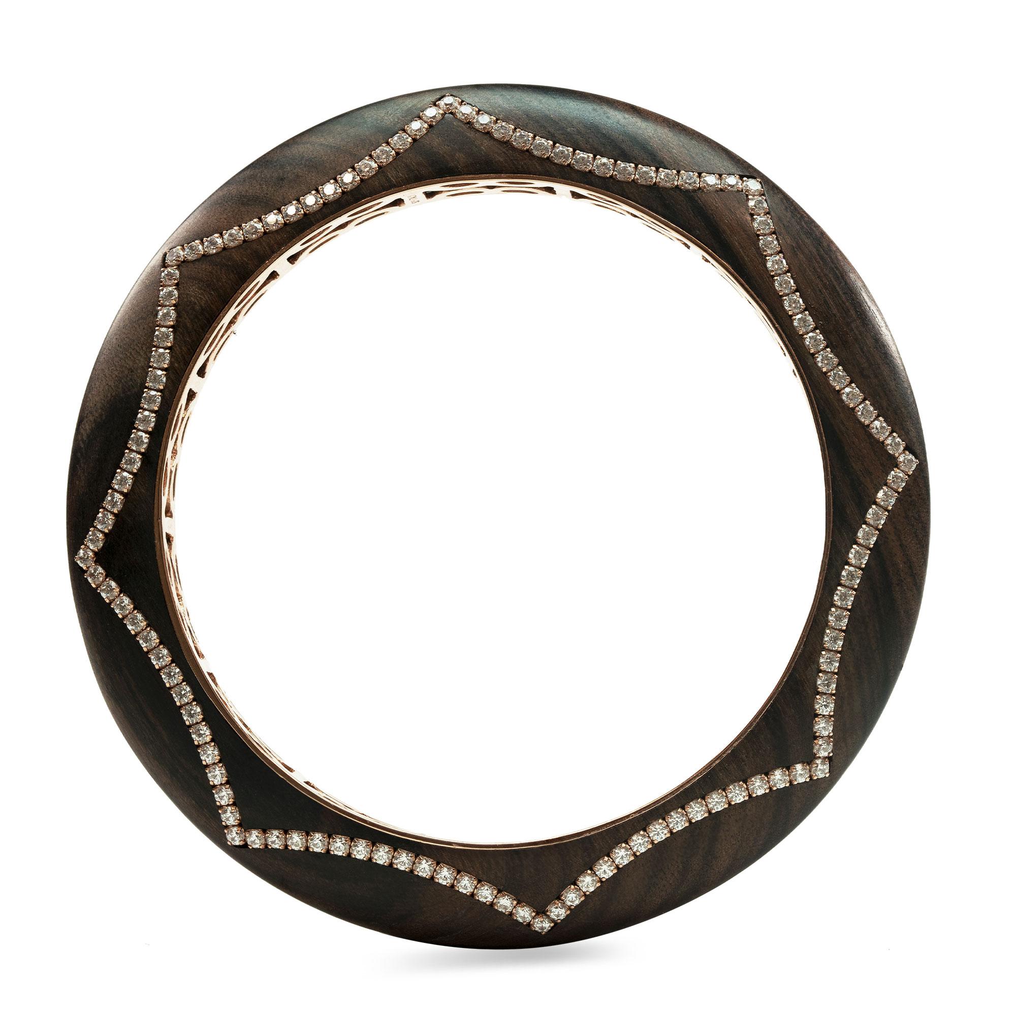 Enairo Rosewood 18k Gold Diamond Bracelet Bangle

This refined piece with its organic shape is carved in stunning rosewood, made of 18k rose gold and set with 240 GVS white diamond stones. 

Our pieces are customizable. Please contact us before