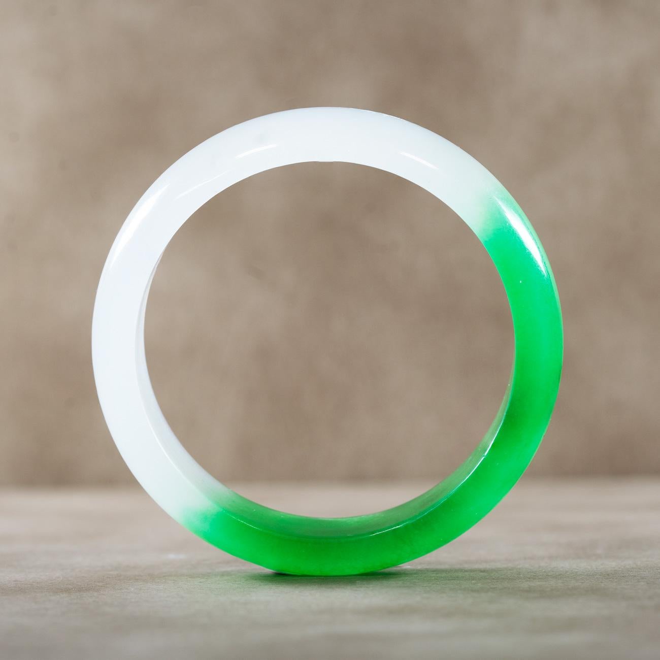 Enairo White and Dark Green Jade Bangle

This versatile bangled is carved in powerful dark green and white jade stone. 

Jade is the symbol of tranquility and purity. It conveys balance and increases the harmony between body and mind. It's a