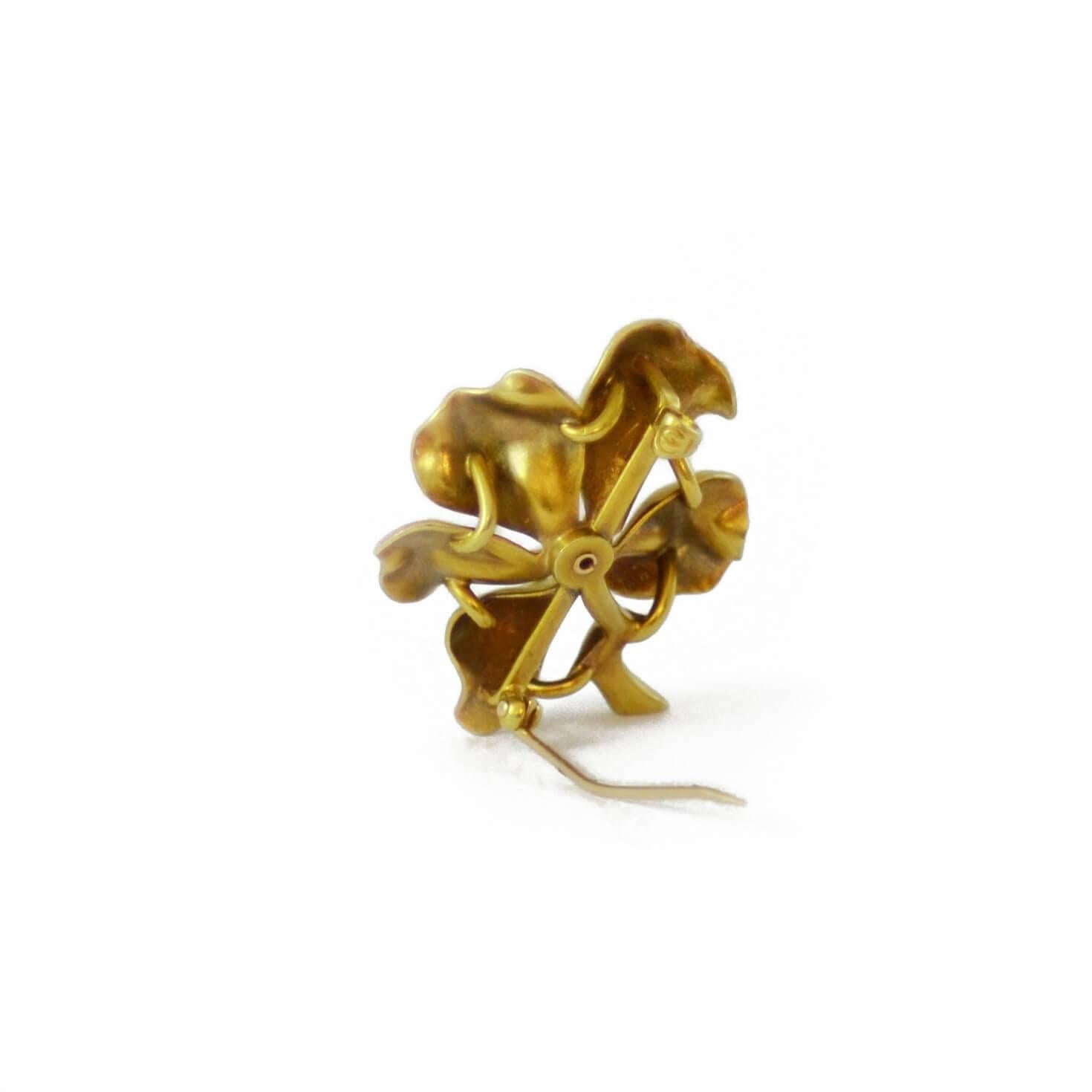 A naturalistically enamelled brooch in the form of cherry blossom, with natural pearl stamen. 14ct yellow gold. American, circa 1890.

