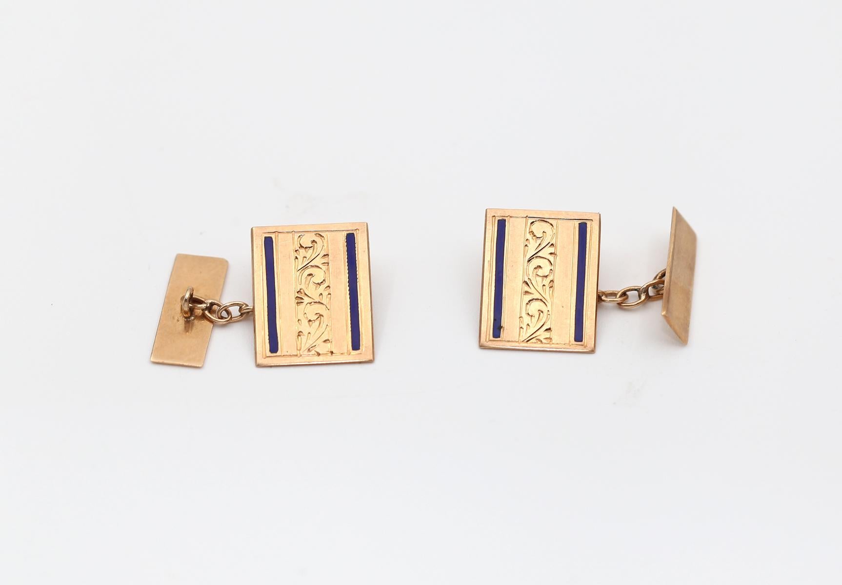 A fine pair of 14k Rose Gold and Enamel Cufflinks.
The deep blue Enamel lines on each side underline the engraved floral motive. 
Delicate and stylish item. Marked.

Engraving on the back of one cufflink says:  5.3.55.
Whoever happens to have a