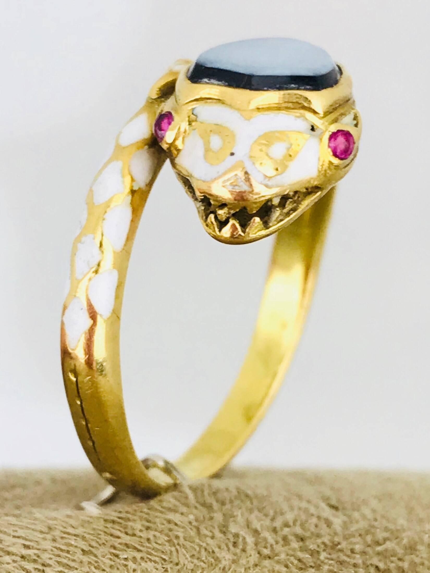 Enamel, 18 karat snake ring with distinguished white enamel contrasting colors upon this beautiful ring. The top head of the snake is a Carnelian Black Onyx which is a white color above black onyx.  The eyes are red rubies measuring 1.35 millimeters