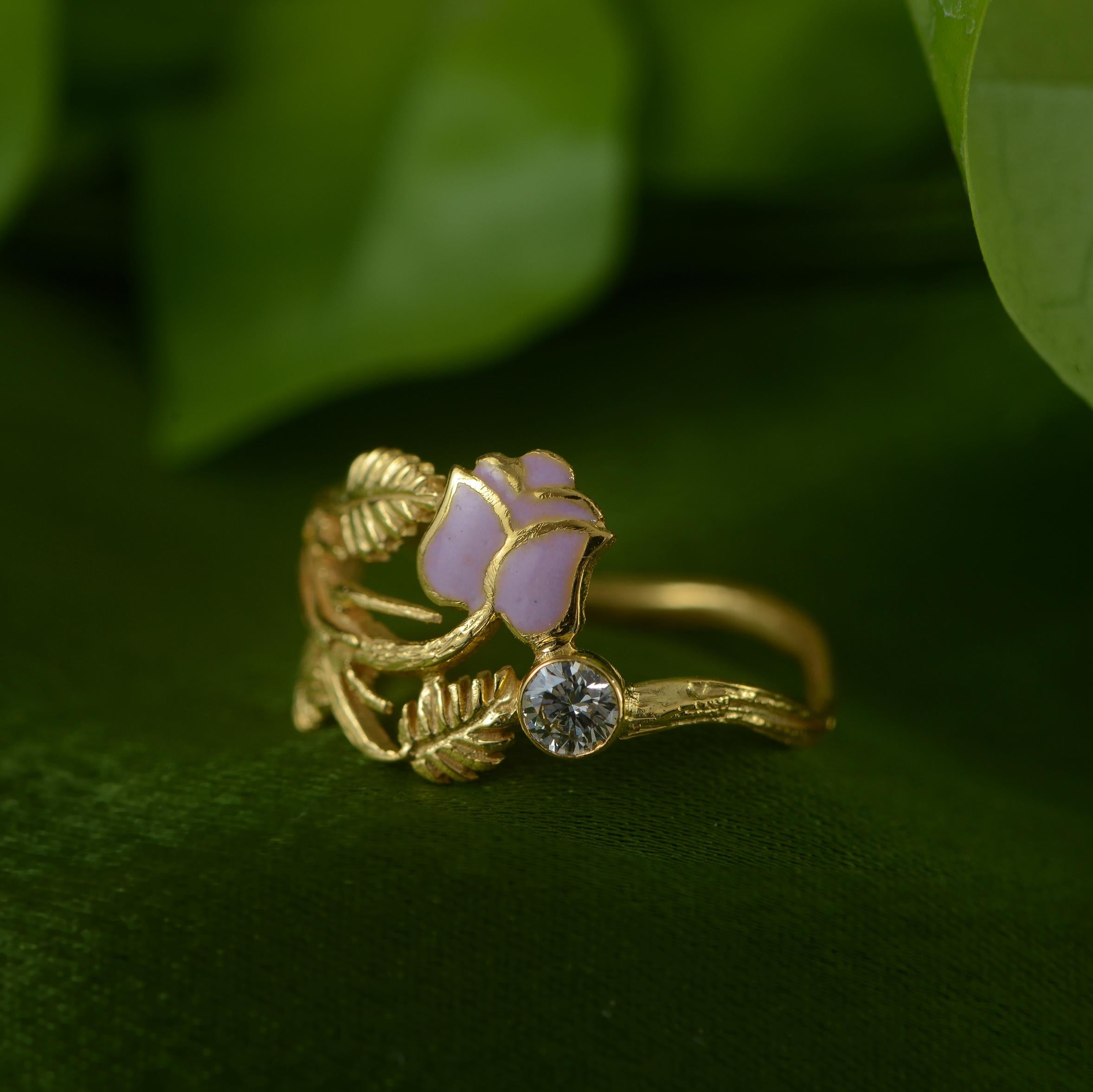 This is a lovely one-of-a-kind handmade  18k gold diamond and enamel flower ring. We have used the ancient art of enamel in this ring and created a beautiful rose, which is flanked by a full cut diamond. The ring also has exquisite hand-engraving