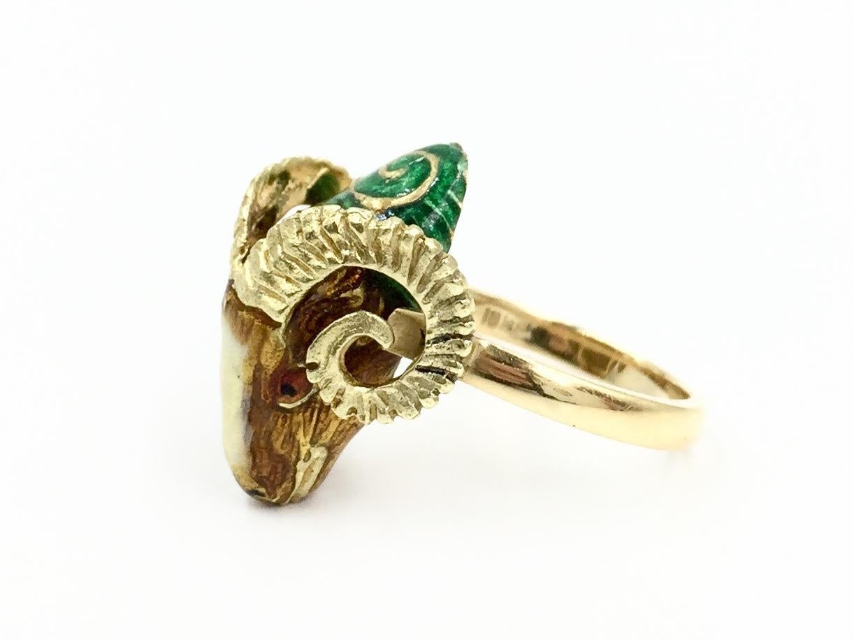 Circa 1960's, this one of a kind ram head 18 karat yellow gold ring features beautiful smooth and polished hand painted enamel. Horns of the ram are perfectly hand carved with great detail. Width of solid gold shank is 3mm. 
Finger size 6