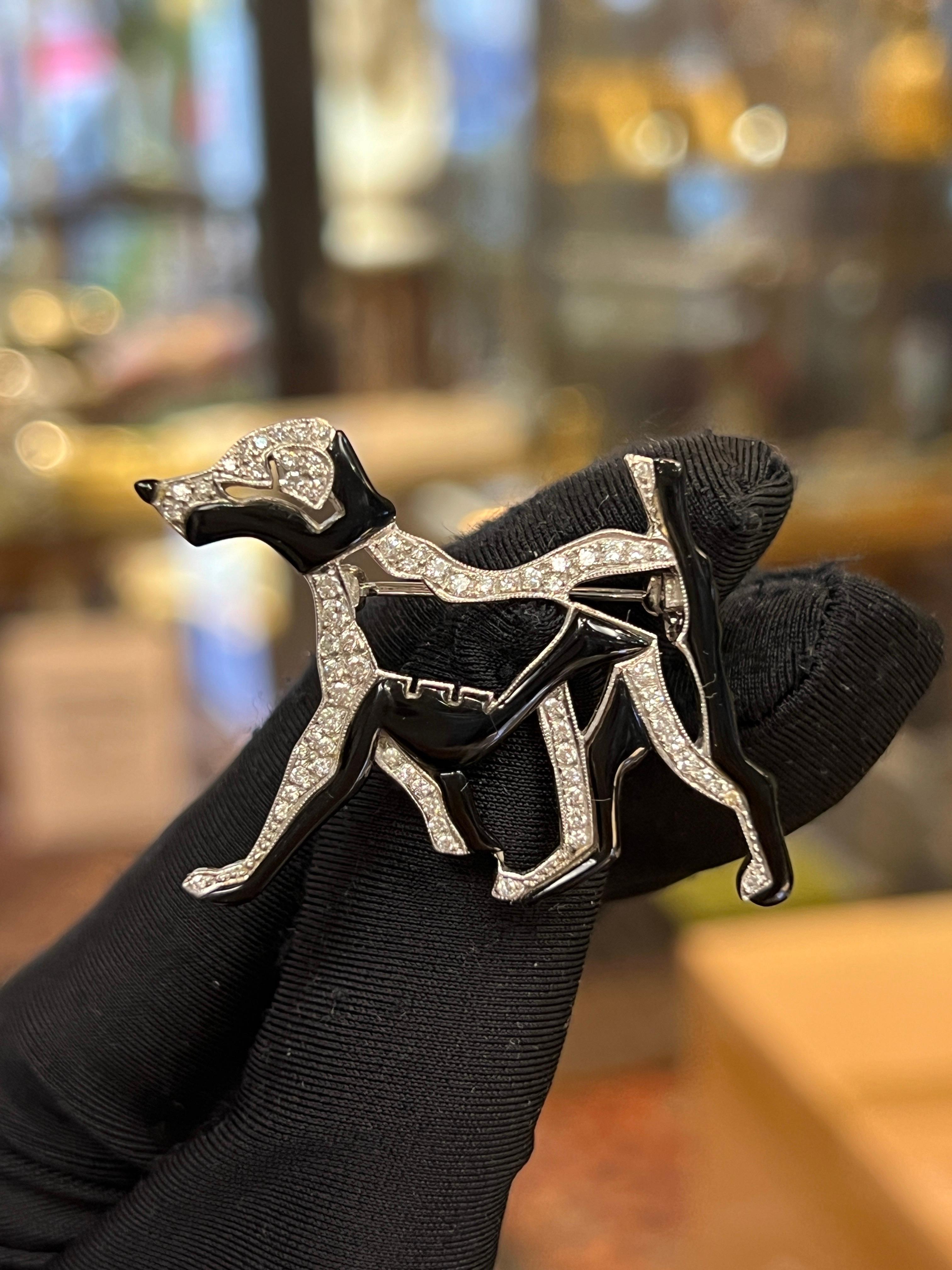 Enamel and Diamond Dog Brooch 

A brooch depicting a dog adorned with round cut diamonds and black enamel 

Approximate Length: 1.5 