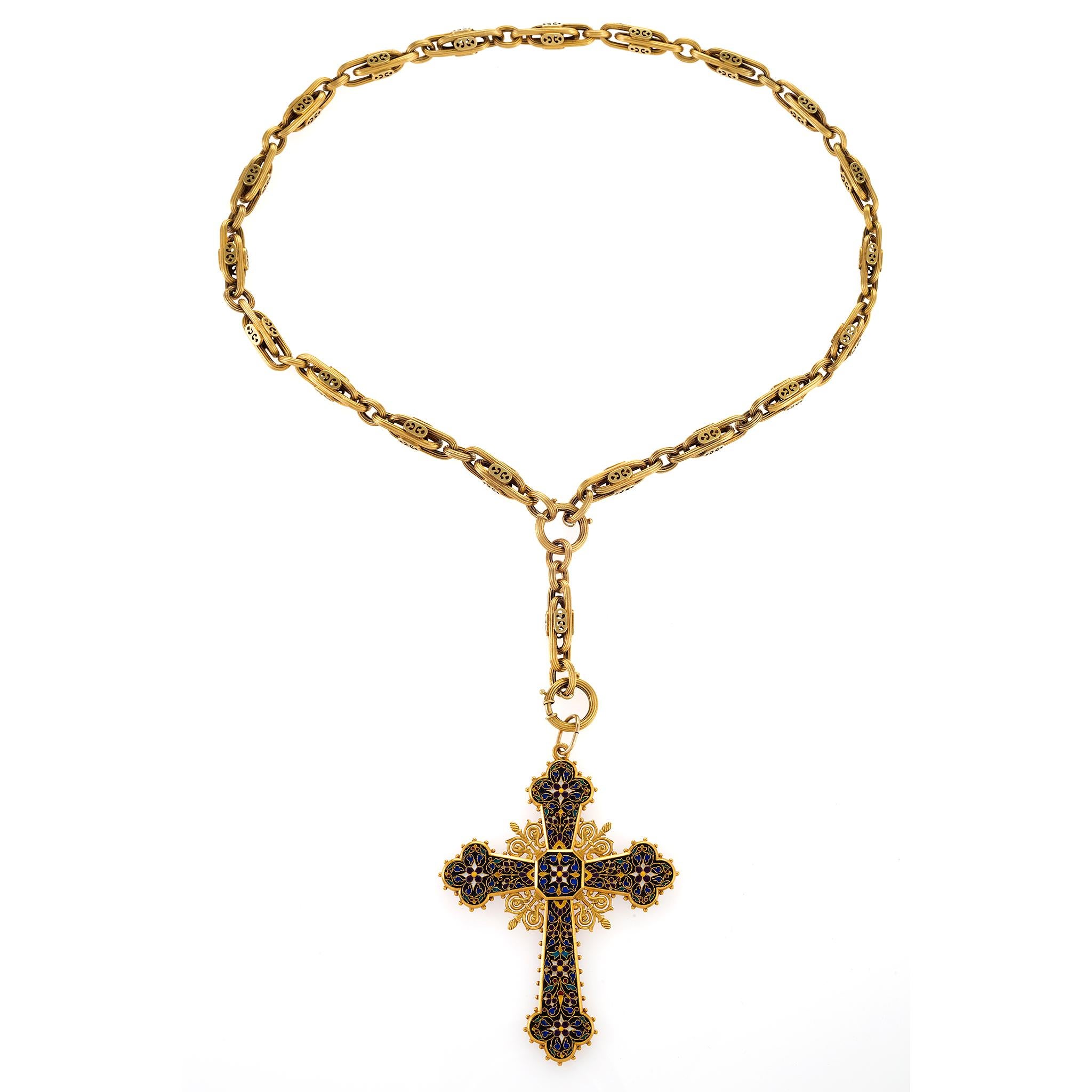 Highlighted by polychrome cloisonné enamel, this 19th century Latin cross pendant is intricately designed with glowing fields of multi-color enamel forming leafy vines and floral motifs. A masterpiece of enameling, it is suspended from an artful,