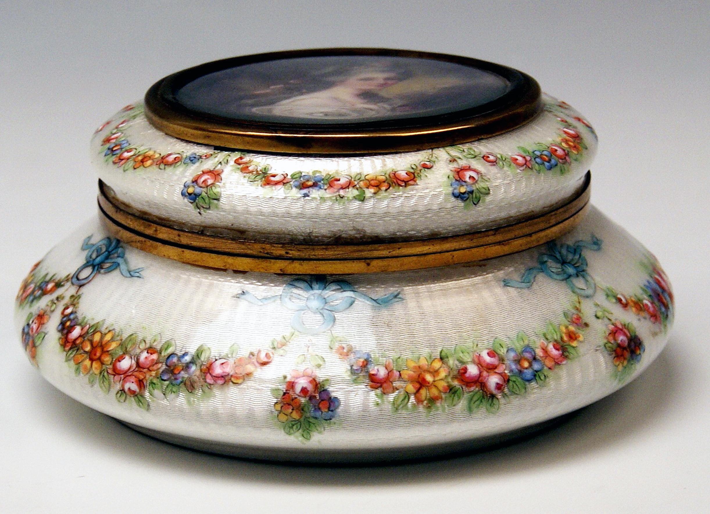 Superb enamel box with flowers garlands and a lady's portrait.

Specifications:
1. The surface of round box is made of white enamel. Additionally, it is stunningly decorated with nicest multicolored flowers' garlands running along the surface /