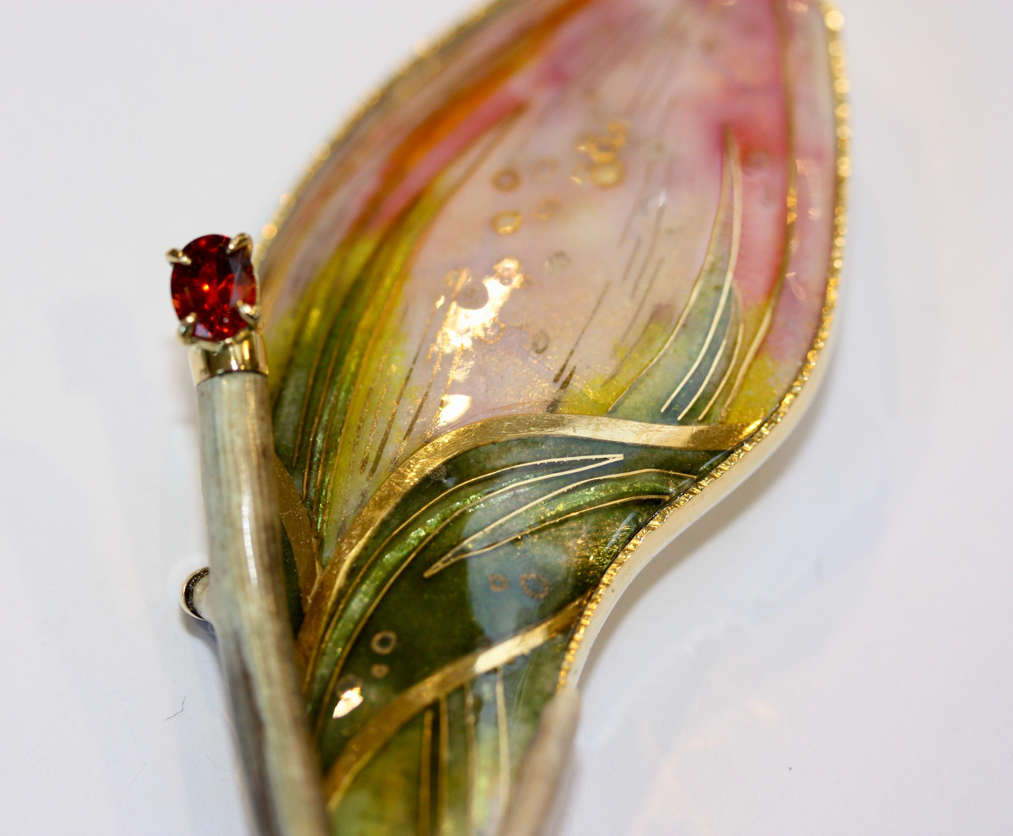 This is one-of-a-kind completely hand made brooch. It is hand signed by the maker and is embellished with a Specatite Garnet, a deep green Tourmeline and Petrified Coral. inlaid is 24K gold while the bezel is of 22K gold. It is stamped with the Gold