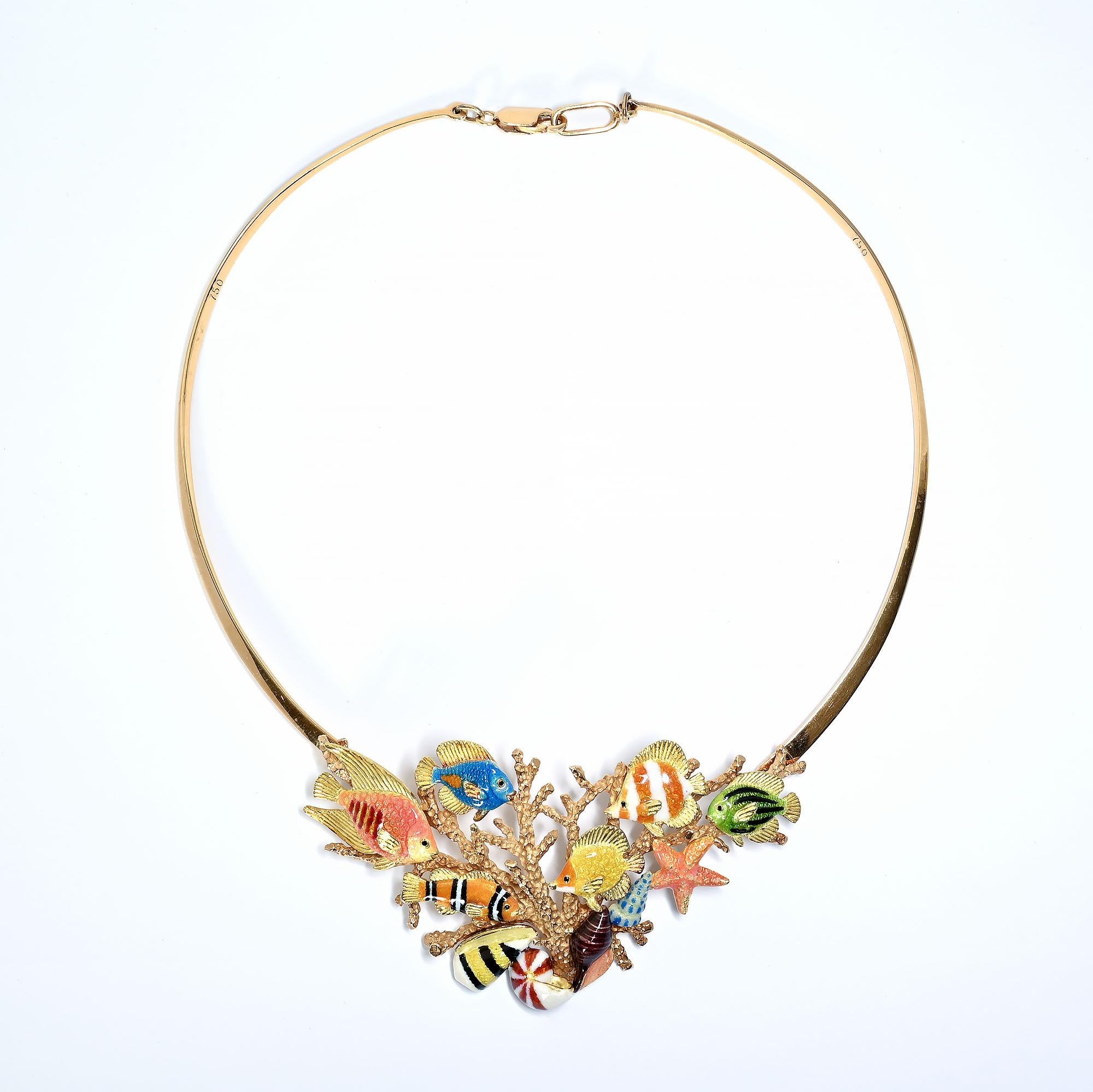 Colorful enamel fish swim around a variety of shells; starfish  and coral in this most unusual 18 karat gold necklace by Kabali. It measures 14 inches from the clasp to the start of the fish medallion and then  extends another 2 inches. Each element