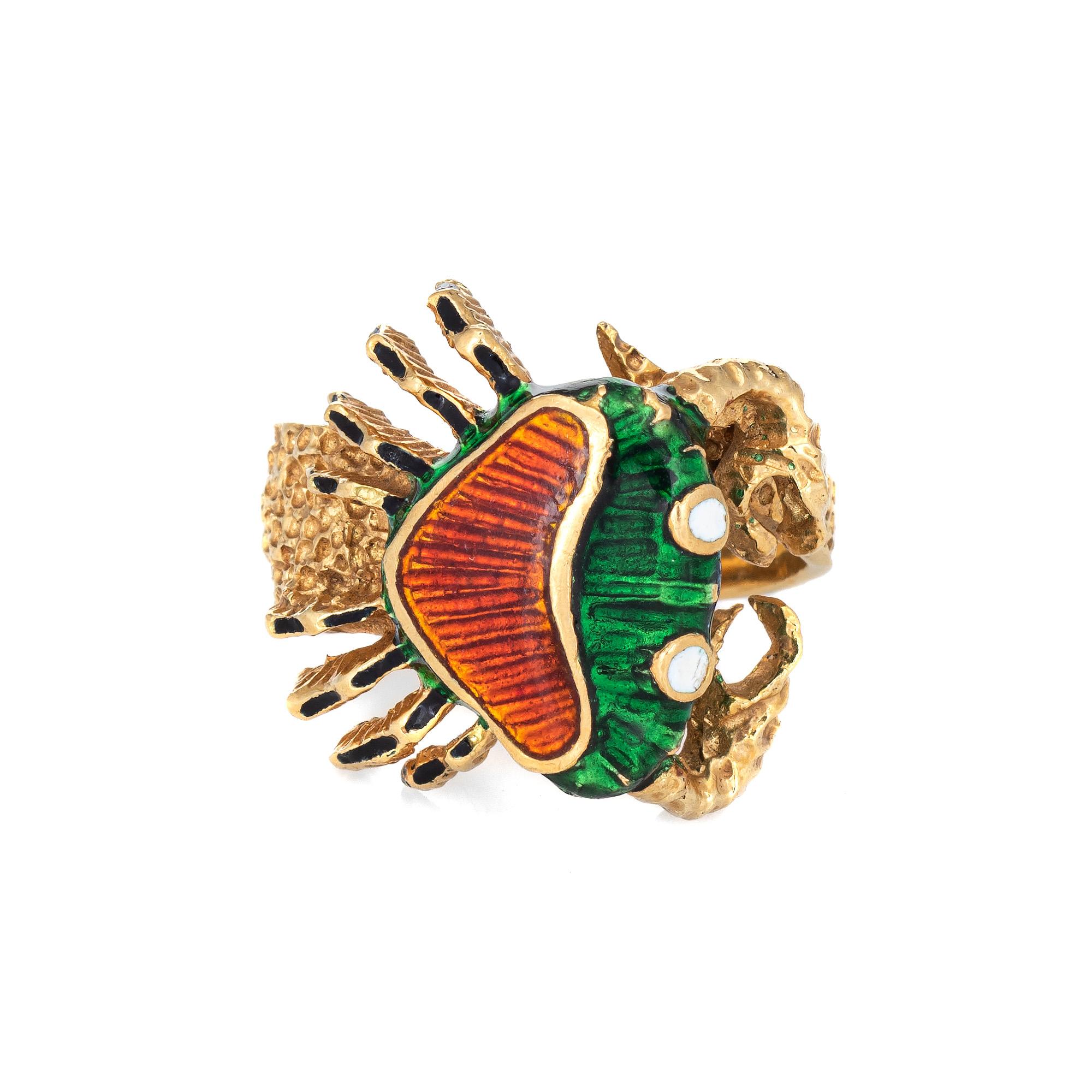 Stylish vintage enameled crab ring (circa 1970s to 1980s) crafted in 18 karat yellow gold. 

Enamel in shades of green, orange, white and black adorn the mount. The enamel is in very good condition and free of cracks or chips.

The finely detailed