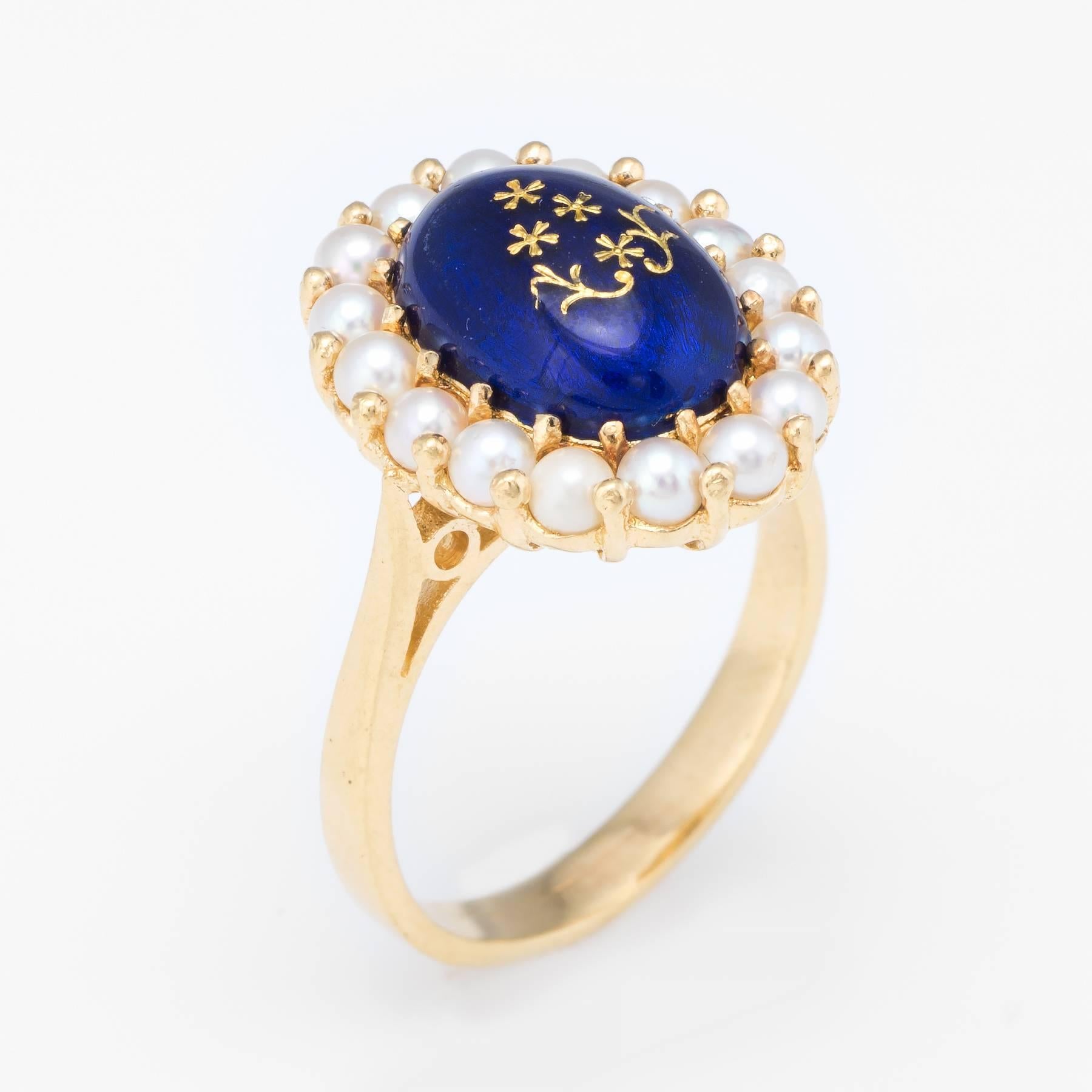 Overview:

Finely detailed vintage cocktail ring, crafted in 18 karat yellow gold. 

Cultured pearls each measure 2.5mm, framing a domed blue enamel center with decorative gold floral detail. 
The pearls are well matching, lustrous and show rose