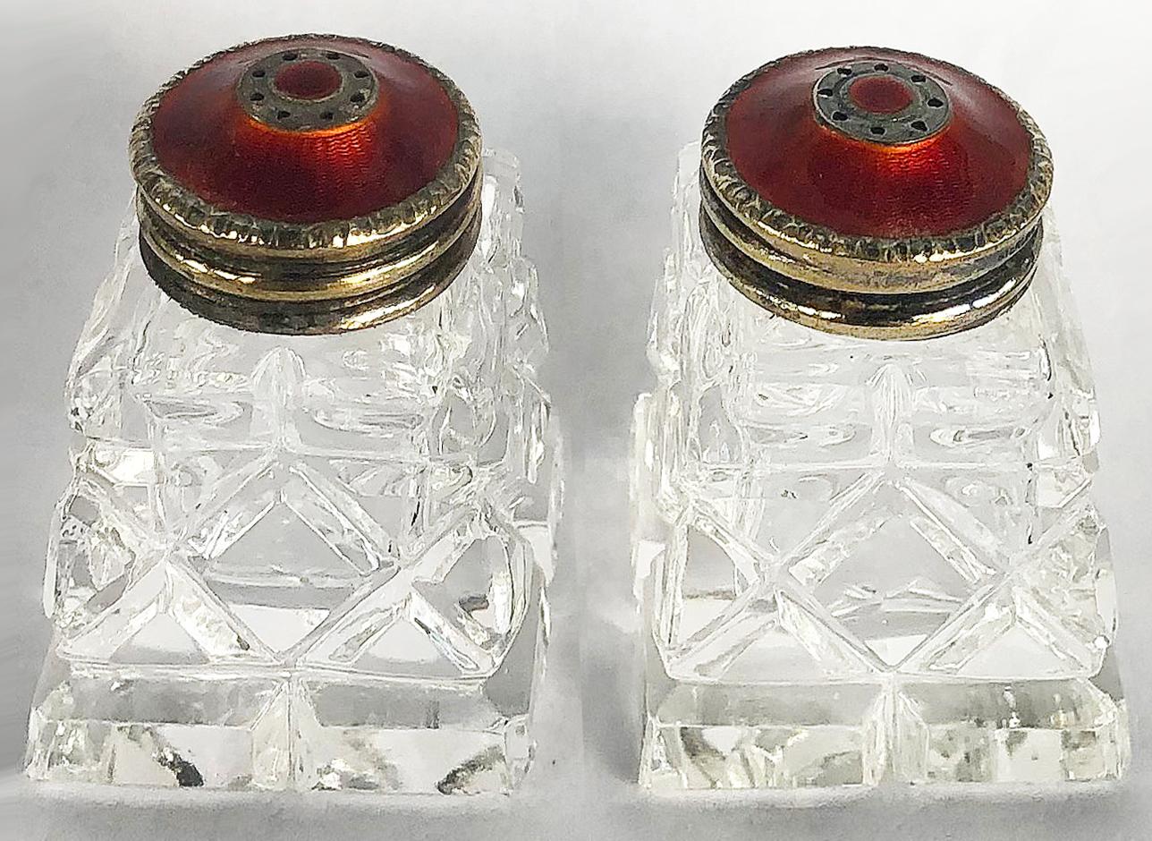 Enamel, cut crystal, sterling silver salt / pepper shakers, a pair.

Offered for sale is a pair of vintage crystal salt and pepper shakers from Norway with sterling tops that have red guilloche enamel work. The tops are stamped sterling and
