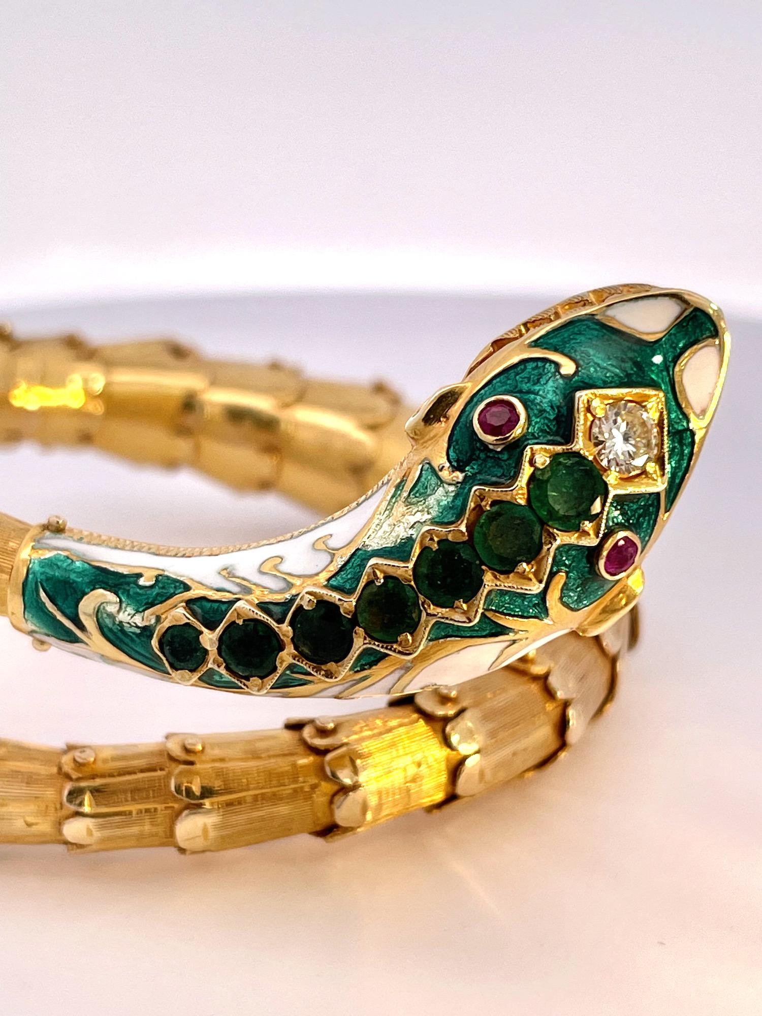 This snake bracelet is quite special as it is enameled in colors of white and green.  It has two ruby eyes, two rubies on the side and a Diamond head.  In addition there are 7 seven Emeralds from the head to the neck.  The Emeralds start at 0.25 cts