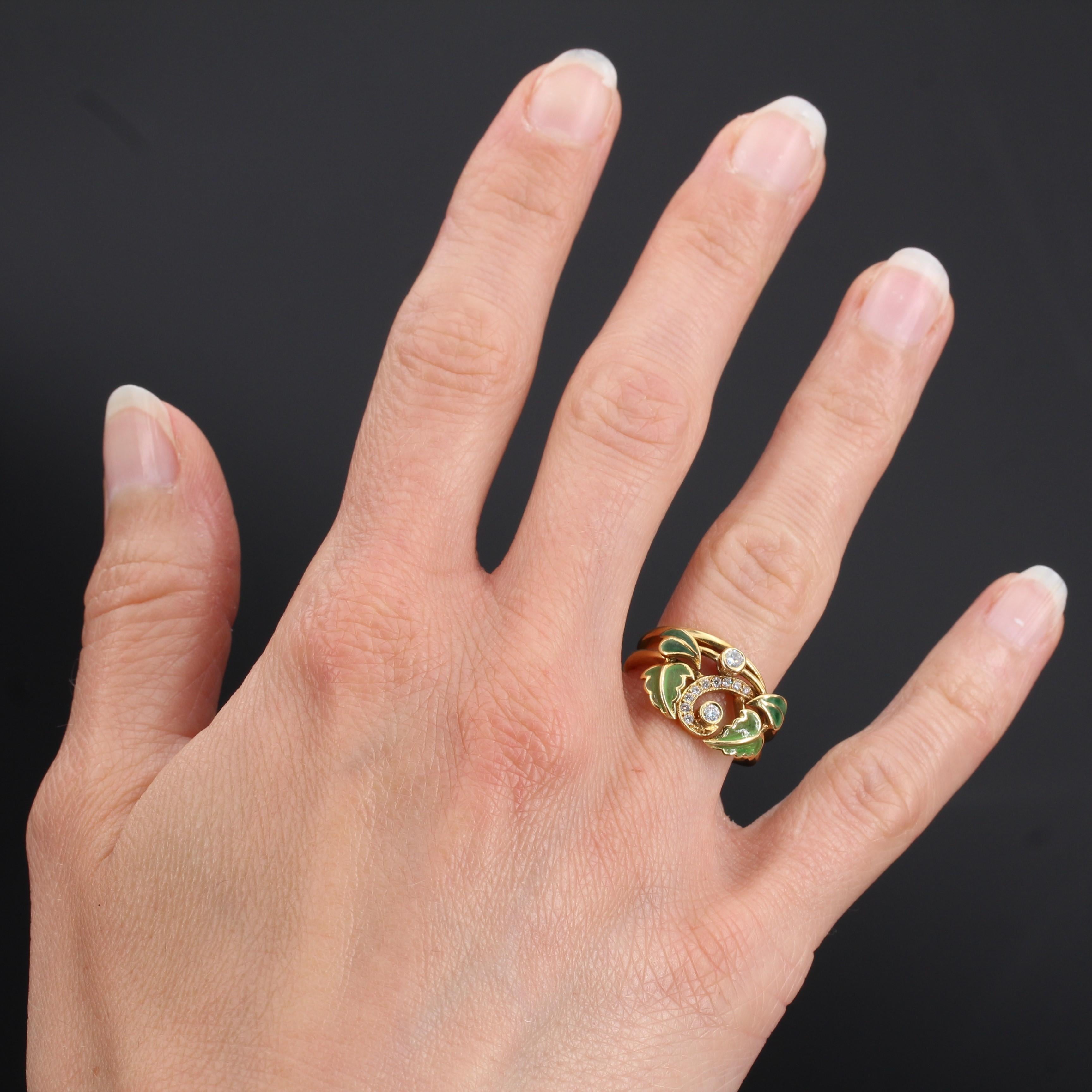 Ring in 18 carat yellow gold, eagle head hallmark. 

This ring is composed of 2 golden bands that are set at the front with 2 bezel set brilliant cut diamonds in an openwork bed set with 9 other smaller diamonds in a curl. On each side are enamelled