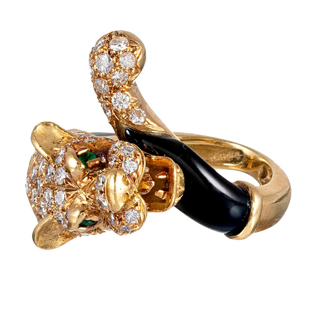 This piece might have been inspired by Cartier’s iconic panther collection. It is created of 18 karat yellow gold and offers dramatic contrast between the black enamel and brilliant diamond-studded head & tail of the big cat it displays. Note the