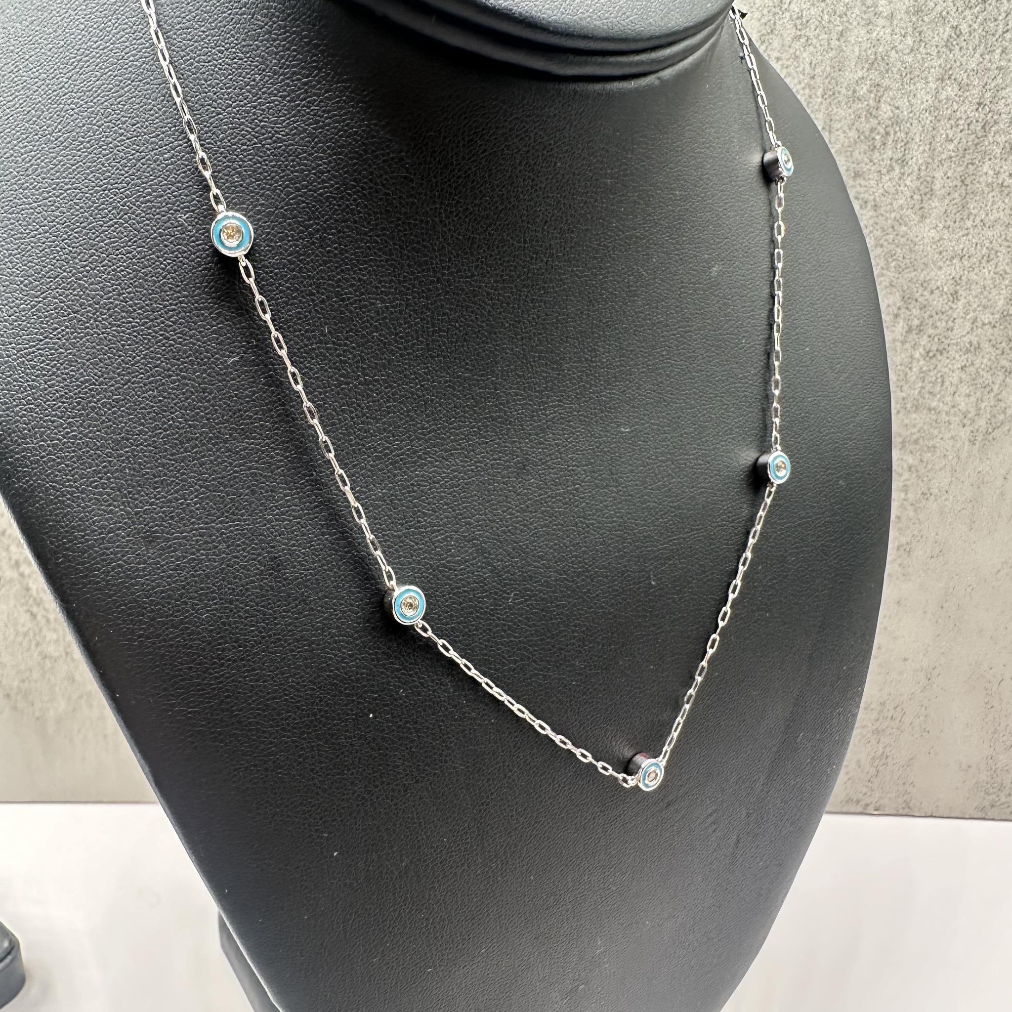 This stylish Enamel and Diamond Station Necklace in 10kt white gold features 0.35ctw of natural IJ I round diamonds and vibrant blue enamel. The necklace includes 5 stations, each with diamonds on both sides, adding a touch of elegance to the