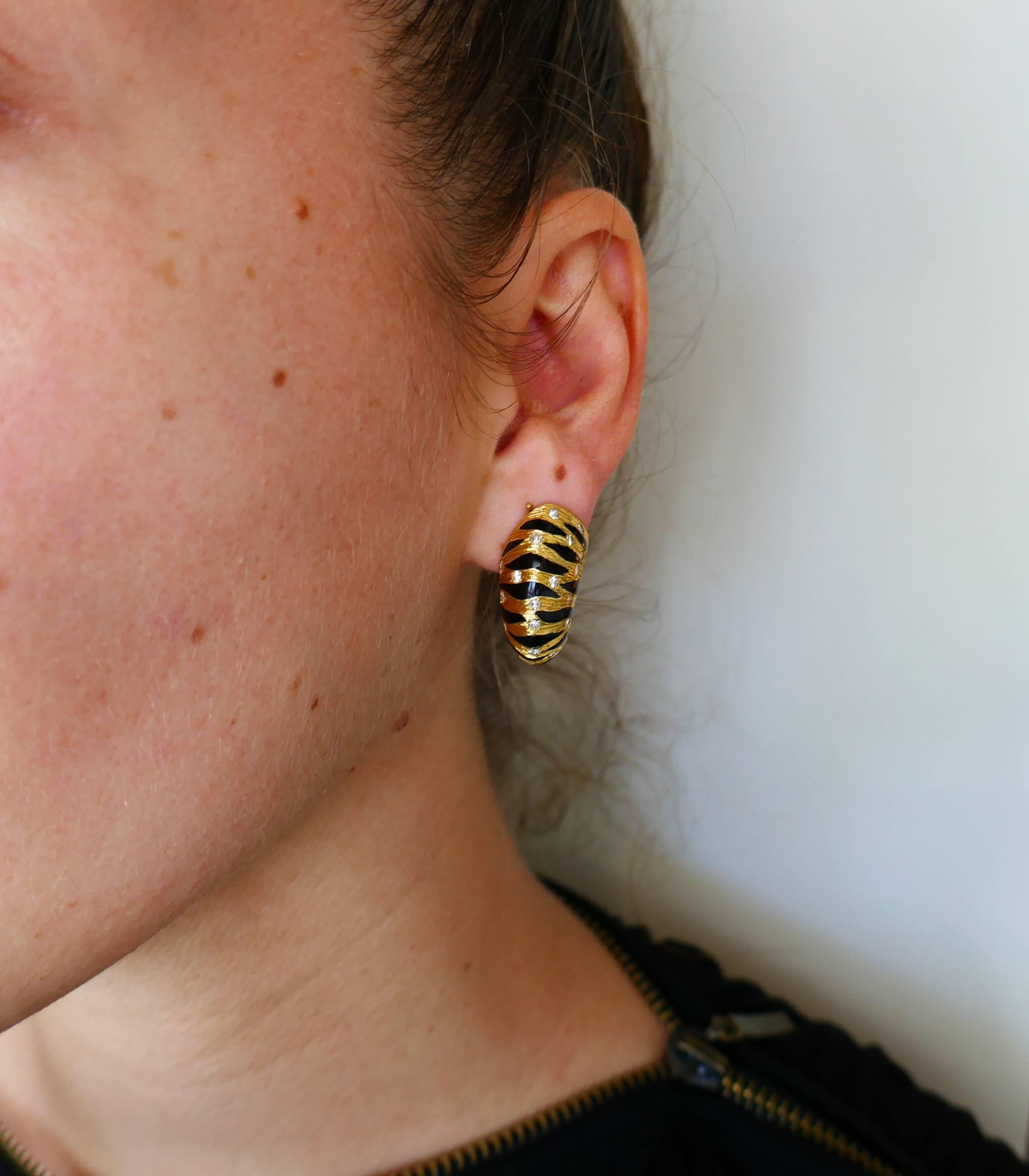 Edgy yet elegant pair of earrings created by Fred, Paris in the 1980s.  Stylish, French chic and wearable, the earrings are a great addition to your jewelry collection. 
They are made of 18 karat yellow gold, black enamel and accented with a round
