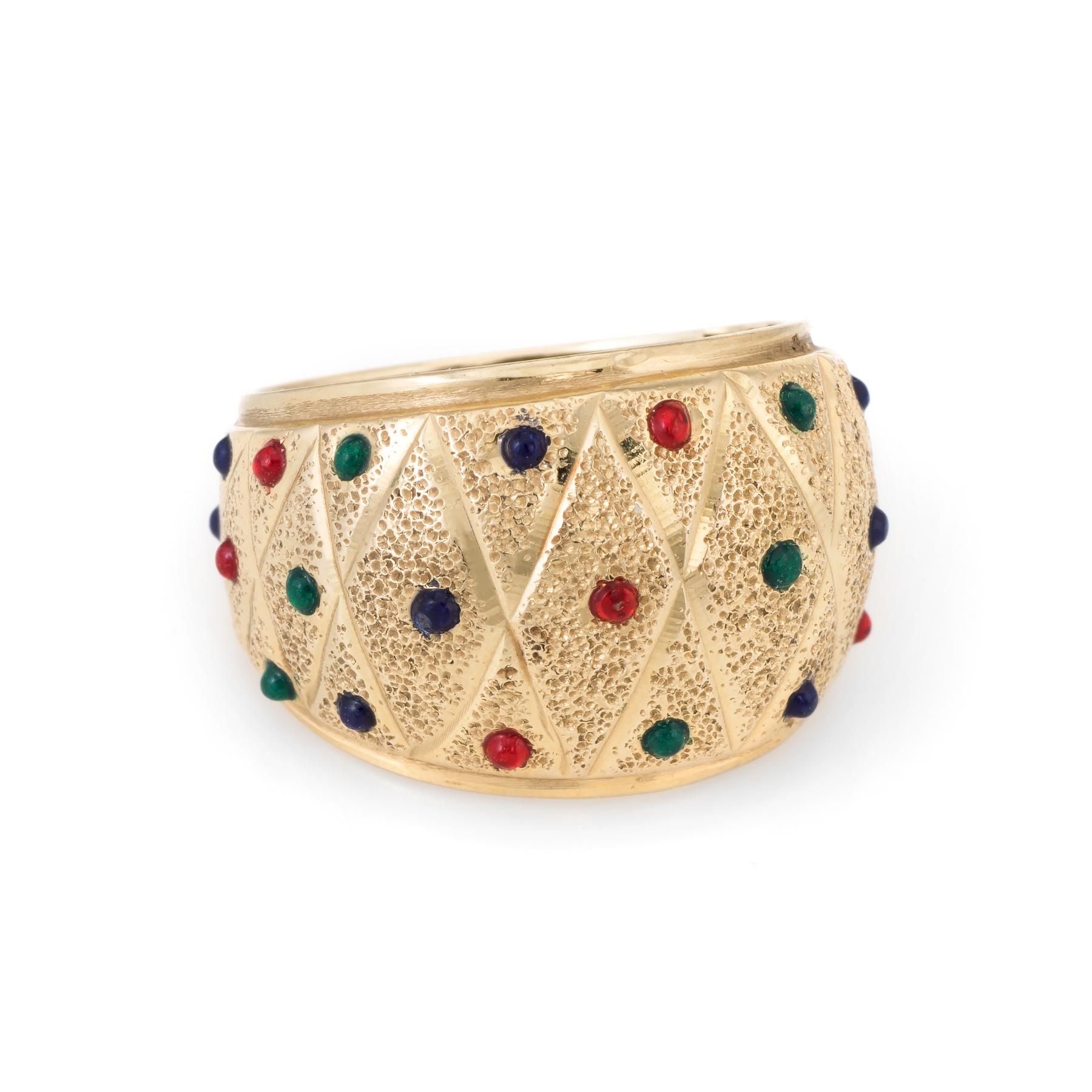 Elegant estate cigar band, crafted in 14 karat yellow gold. 

Blue, red and green enamel dot the textured dome mount. 

The ring is in excellent condition. 

Particulars:

Weight: 4.6 grams

Stones:  N/A.    

Size & Measurements: The ring is a size