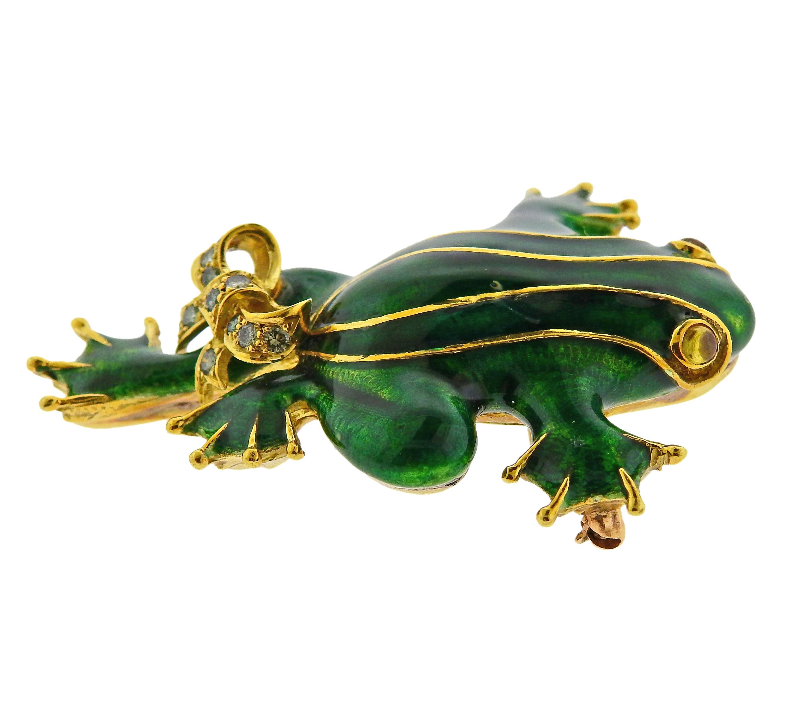 18k yellow gold and enamel frog brooch, adorned with a bow, set with approx. 0.20ctw in fancy bluish/teal diamonds and citrine cabochon eyes. Brooch measures 2 1/16