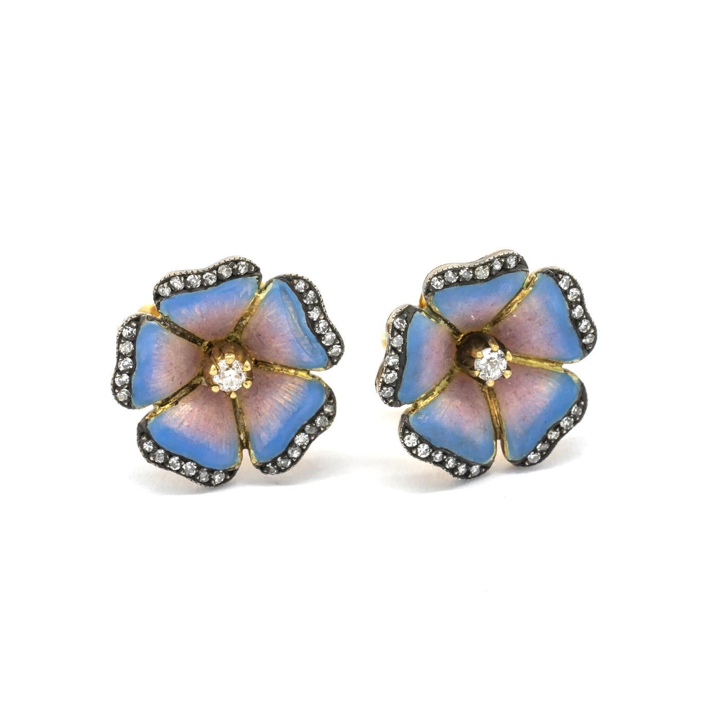 A pair of enamel flower earrings, with sky blue to pink basse taille enamel petals, with an old-cut diamond in the centre and eight-cut diamonds set in the petal edges, mounted in gold with silver settings.