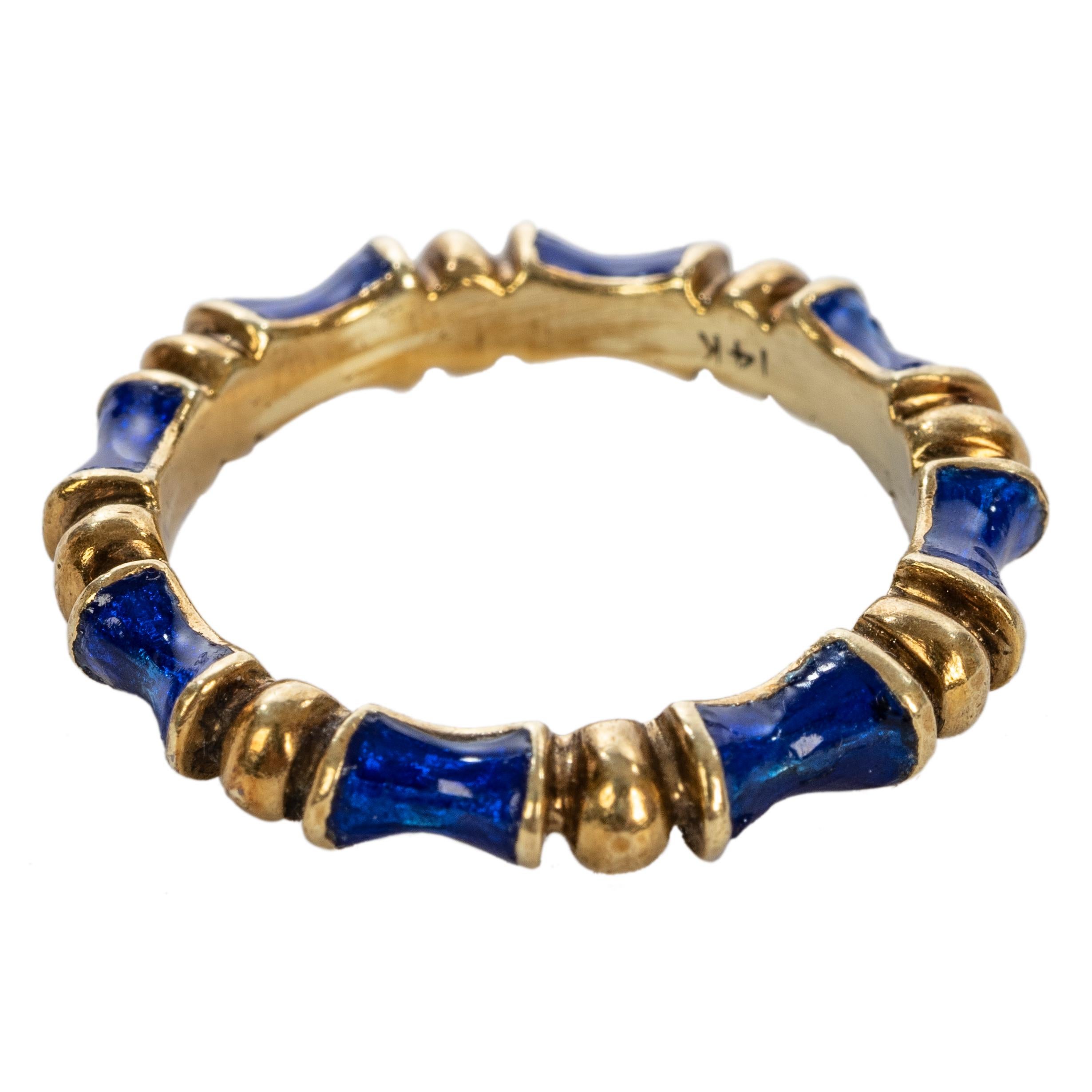 This wonderful 14k yellow gold band is of sculpted bamboo design with alternating sections of translucent cobalt blue enamel.

Mid 20th century.

Size 7.