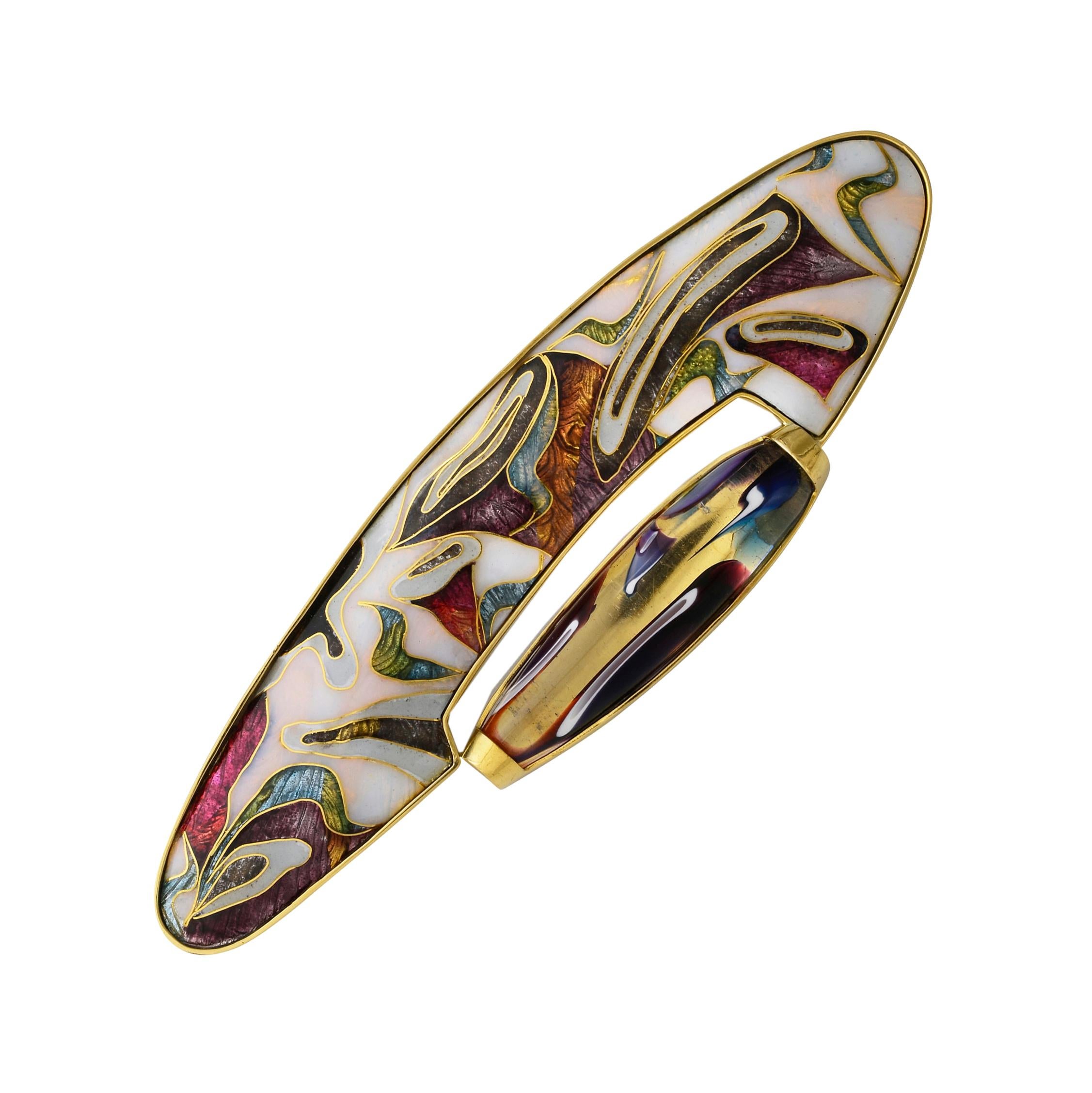 A very beautiful and unusual cloisonné brooch/pendant is a one-off piece of hand made art jewellery.
It is set in a bezel of 22Karat gold with a  sterling silver back plate. As part of the design, a superb piece of dichroic glass embellishes the