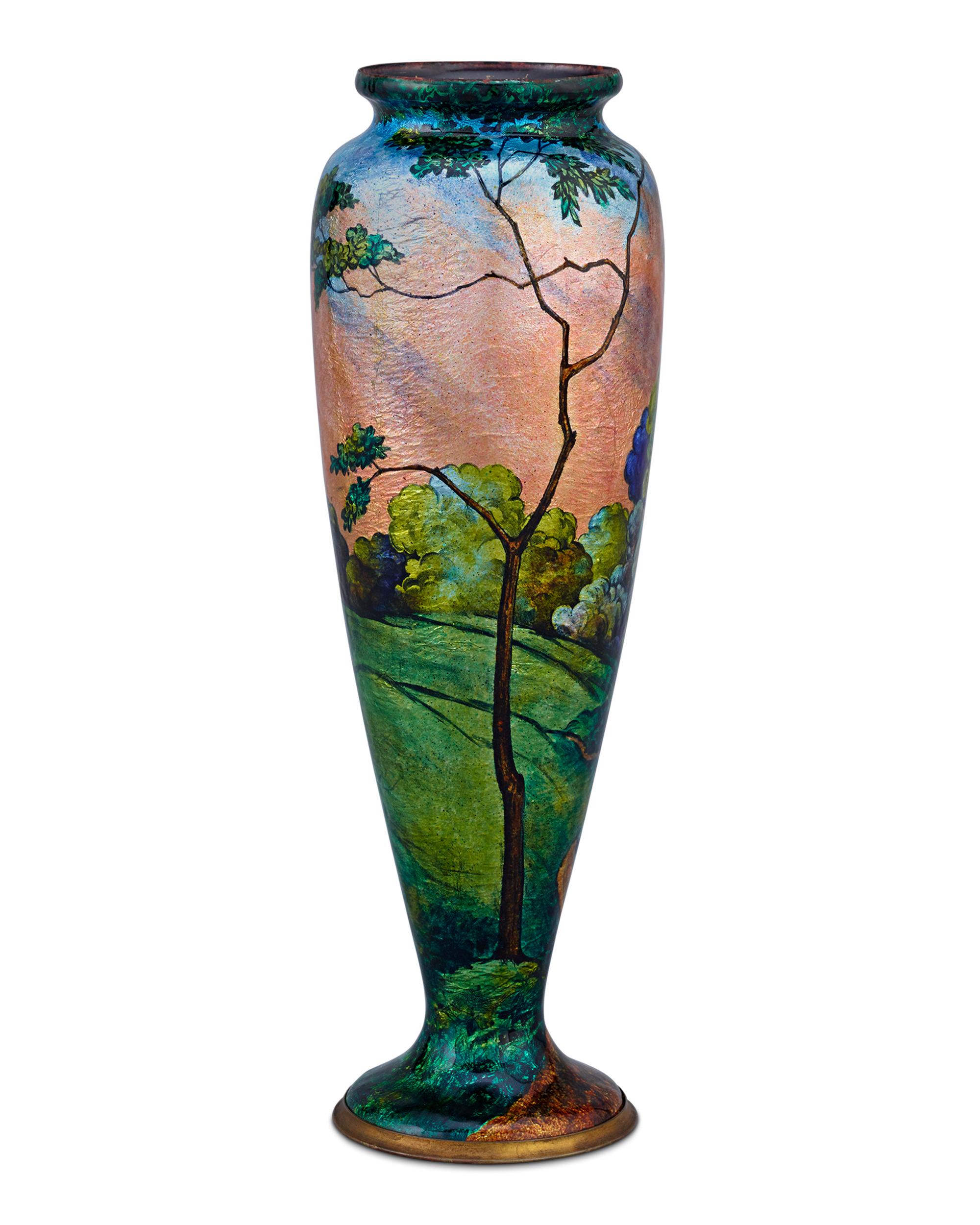 An enameled landscape awash with the soft light of dusk decorates this vase by the renowned Camille Fauré. It demonstrates Fauré's signature raised enameling, which is achieved by applying silver leaf and an enamel paste to a copper form and
