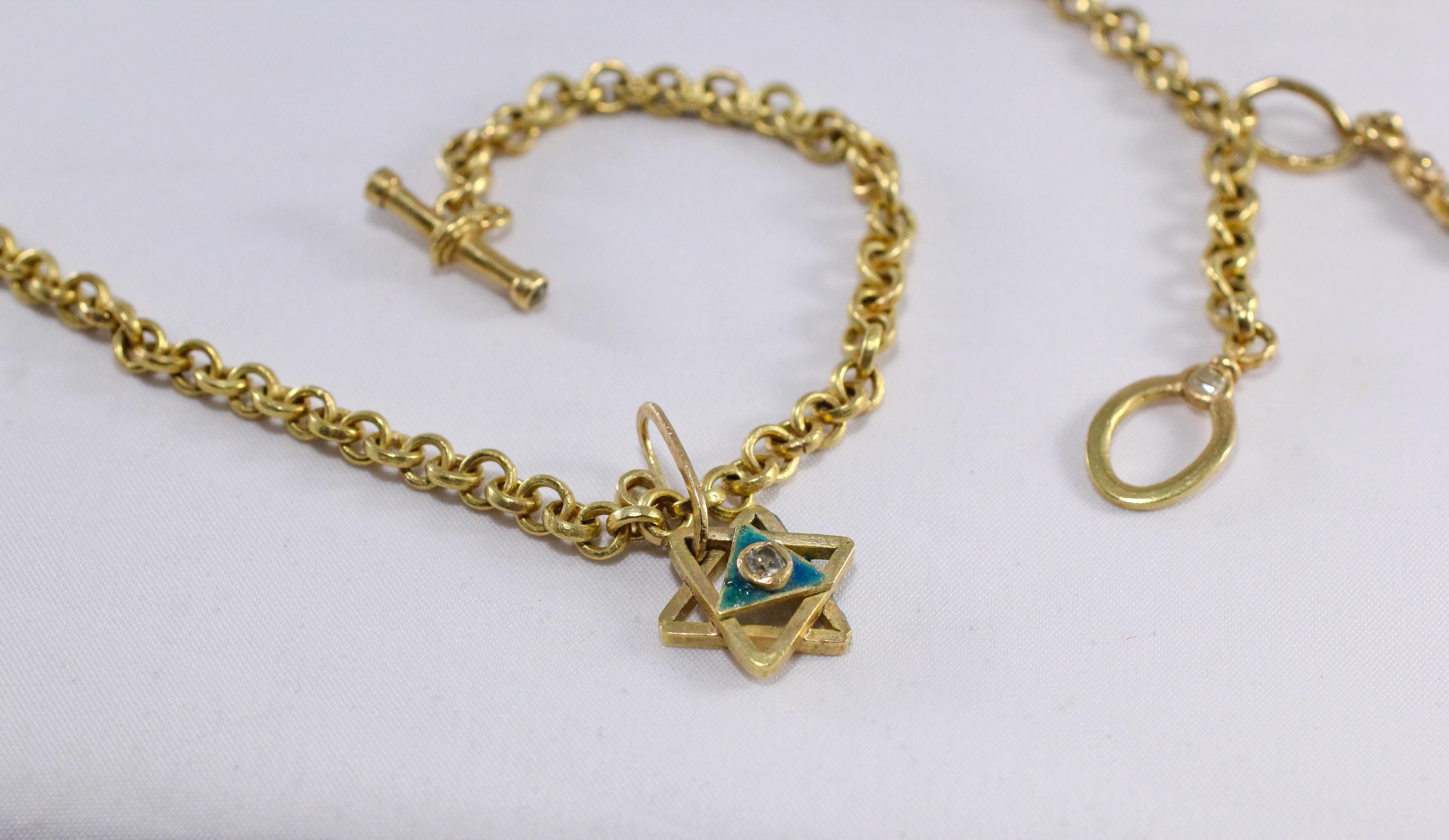 An enameled Magen David on a hand-crafted drop link necklace with a diamond enhancer. All are in recycled 18K gold. A bold symbol of faith and spirit this beautiful Magen David is hand fabricated, enameled in colors of Eilat or King Solomon Stone,