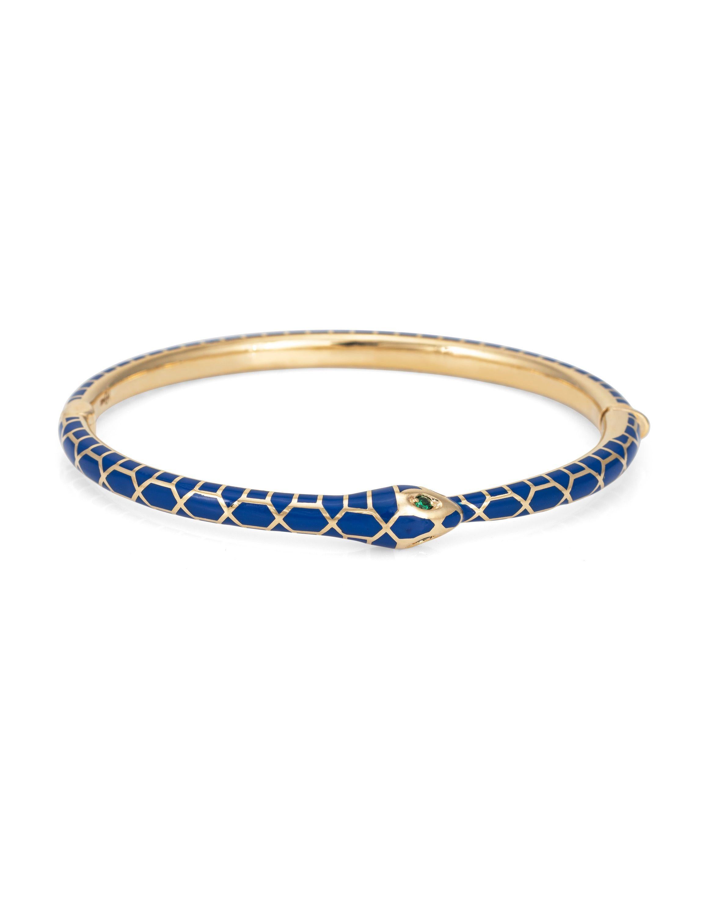 Our 14k yellow gold ouroboros bracelet is a symbol of wholeness and eternity. The bracelet is beautifully detaled with blue enamel and emerald eyes, secured with a push button lock closure.   Internal diameter is 2
