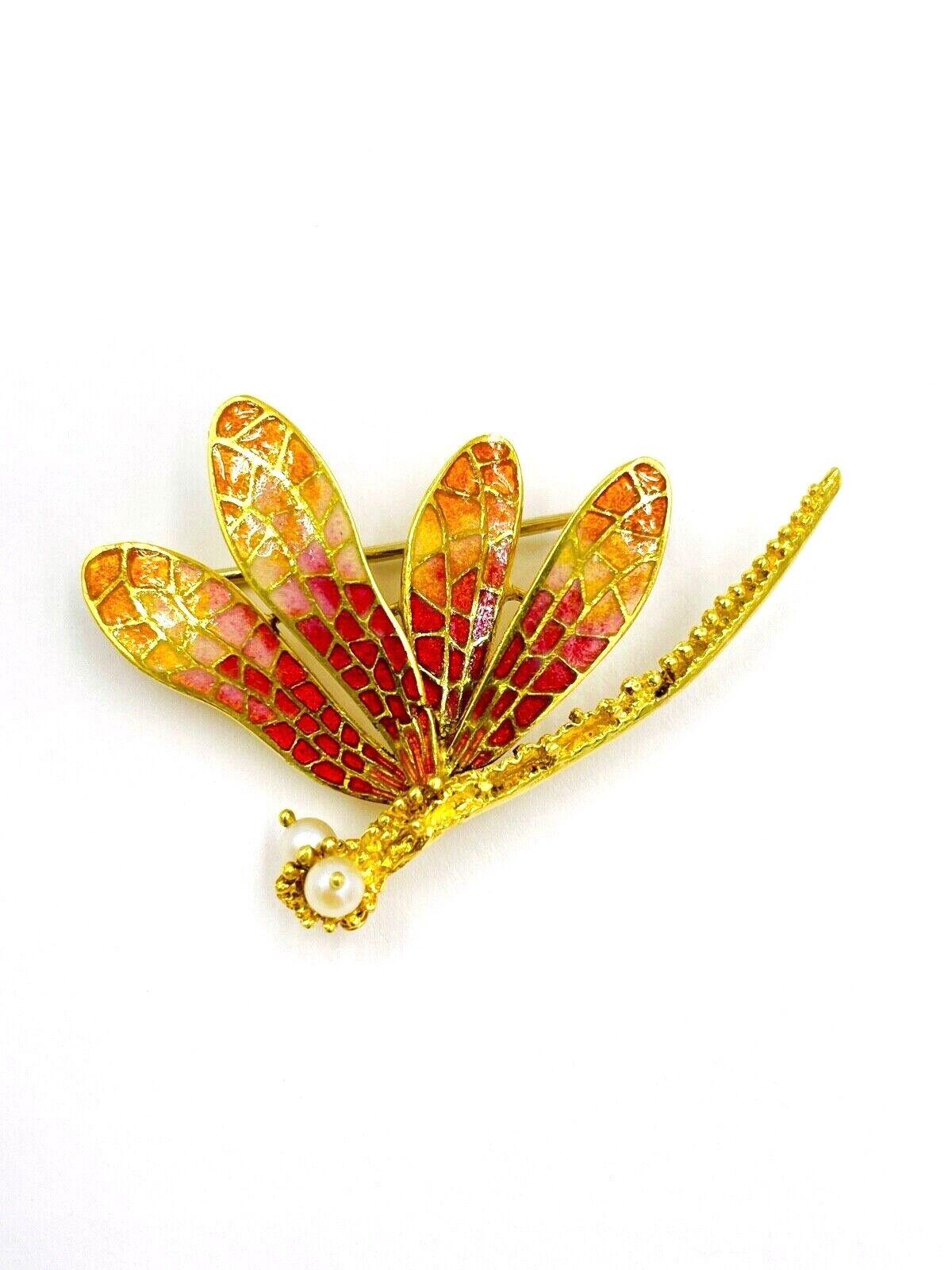 Enamel cultured pearls and yellow gold dragonfly brooch circa 1960. *

ABOUT THIS ITEM:  #P-DJ624G. Scroll down for specifications.  The wings are decorated by enamel ranging in shades of coral, pink, and orange colors, and the eyes are formed by a