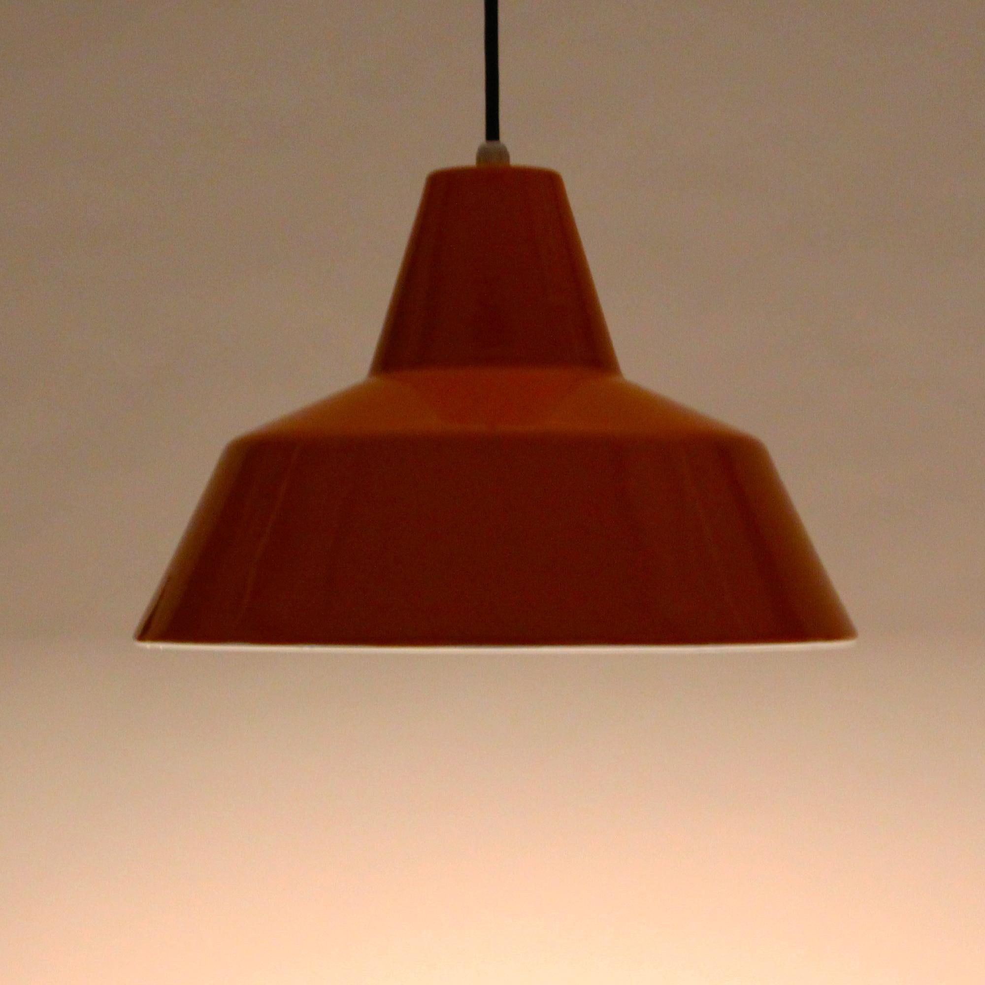 Enamel Pendant, Classic midcentury industrial workshop light produced by Louis Poulsen in the 1960s and in excellent vintage condition.

A large metal pendant with bright orange enameled outer and bright white enameled inner. The white inner gives