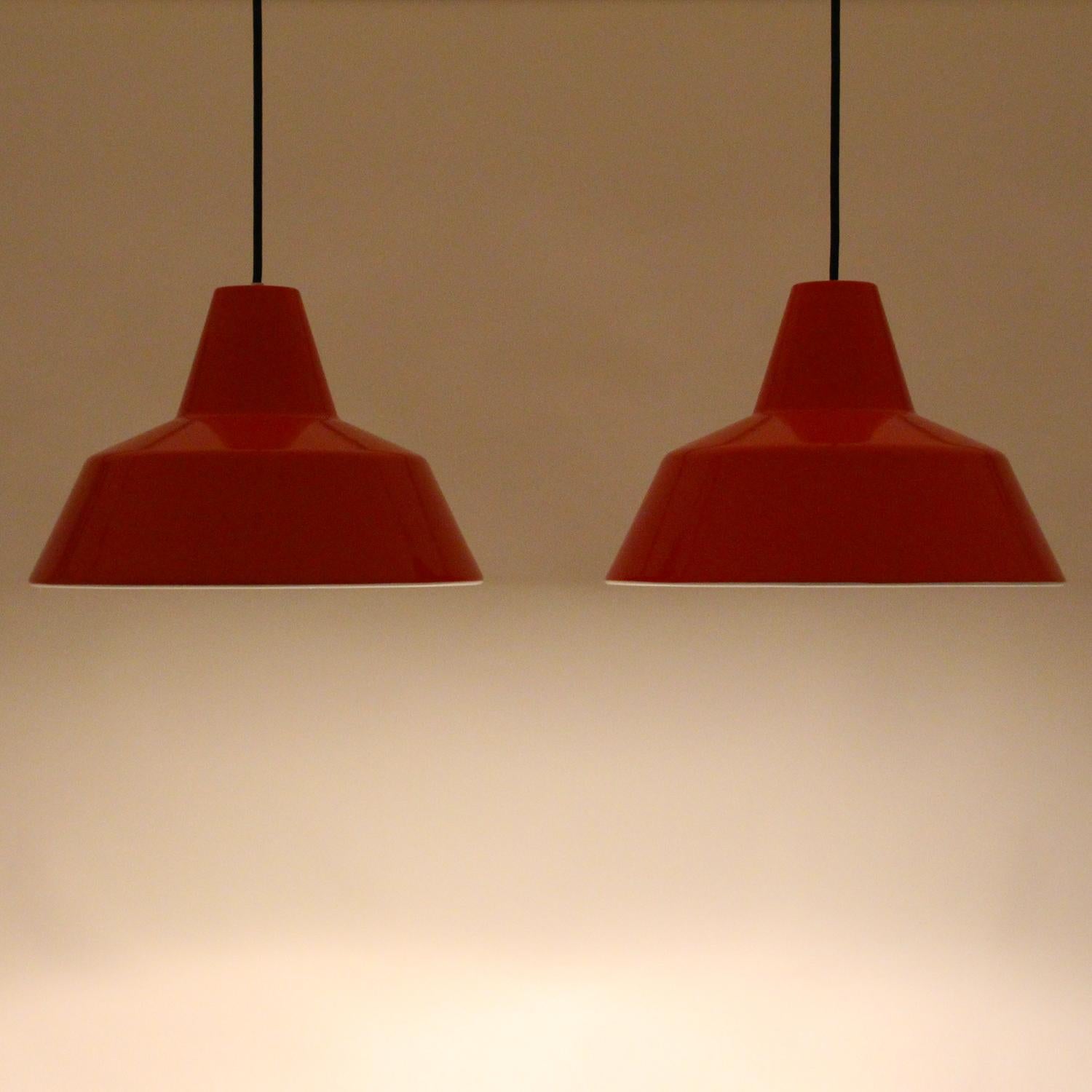 Enamel pendant pair by Louis Poulsen in the 1960s - pair of Classic midcentury Industrial workshop lights with coral red (orange-red) enamel in excellent vintage condition.

Up for sale here is a pair of large ceiling lights, made up by a