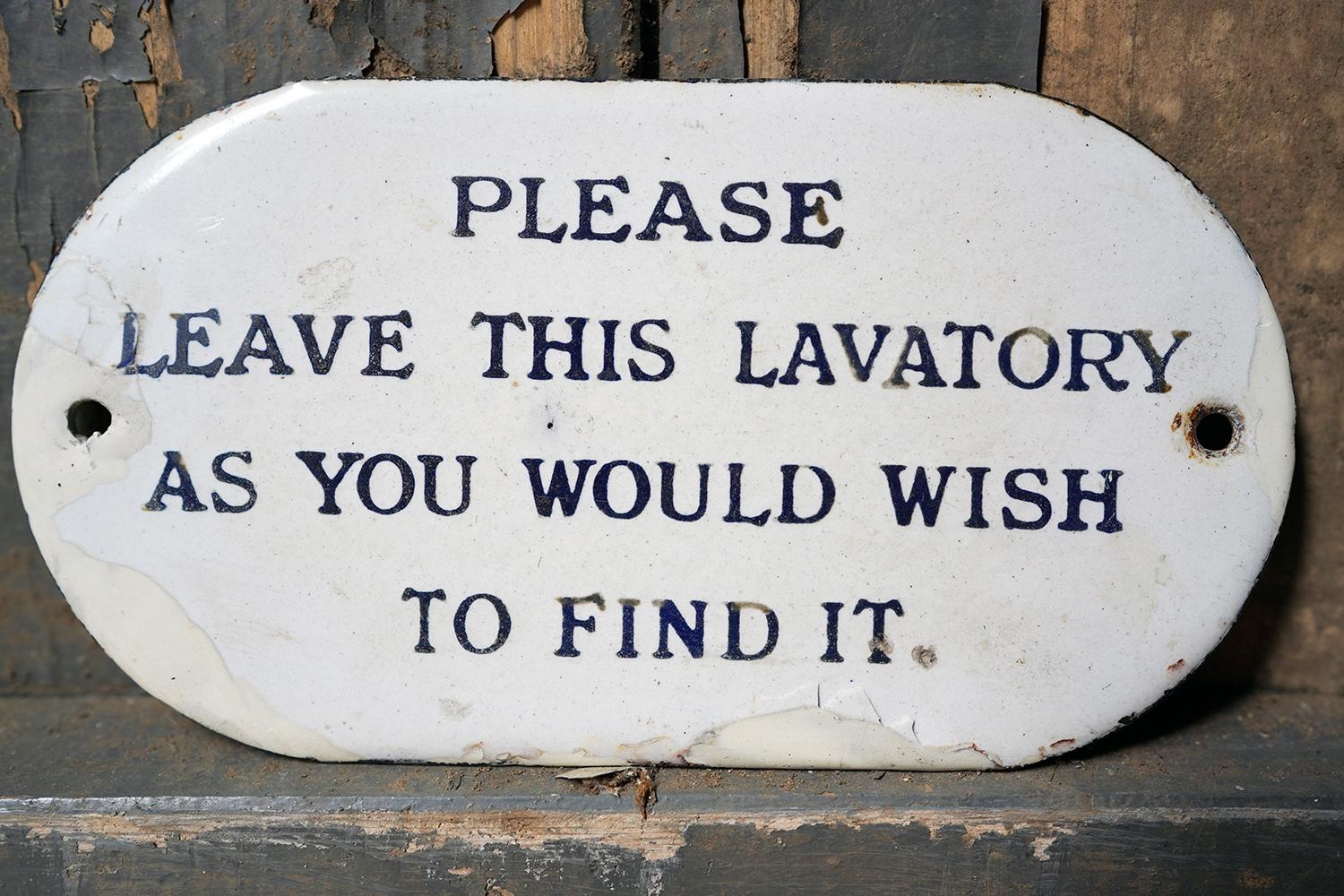 The ellipse shaped painted enamel railways sign, in peacock blue lettering to an ivory ground reading ‘Please Leave This Lavatory As You Would Wish to Find It’ in capital lettering, and surviving from the first quarter of twentieth century