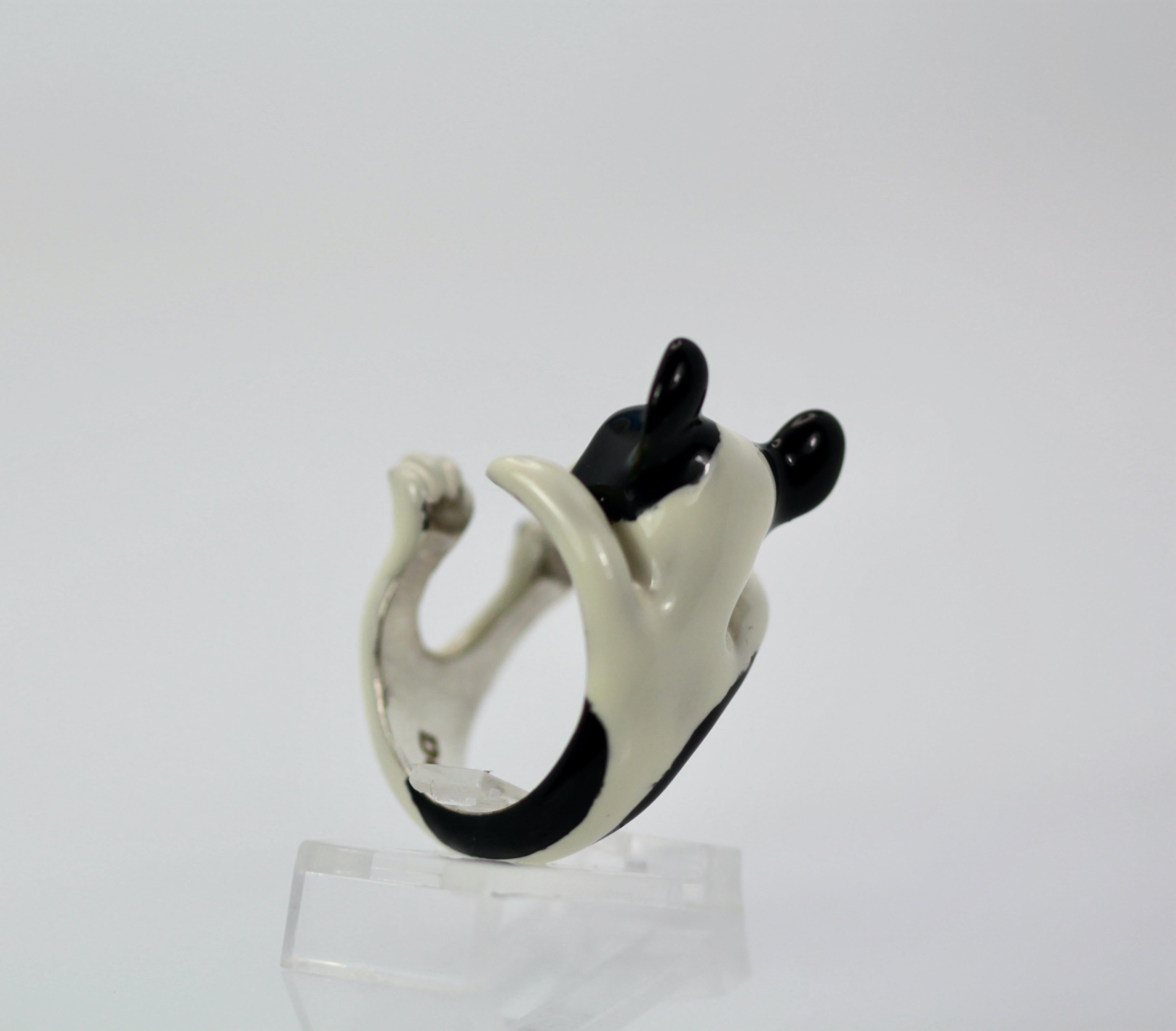 This ring depicts a boston terrier and is just delightful.  This ring is made in sterling silver with a Ceramic enamel body.  This ring is size 7 is 15.5 grams and is 20.64 mm across.  This Boston Terrier has a cute face an is so unusual I have